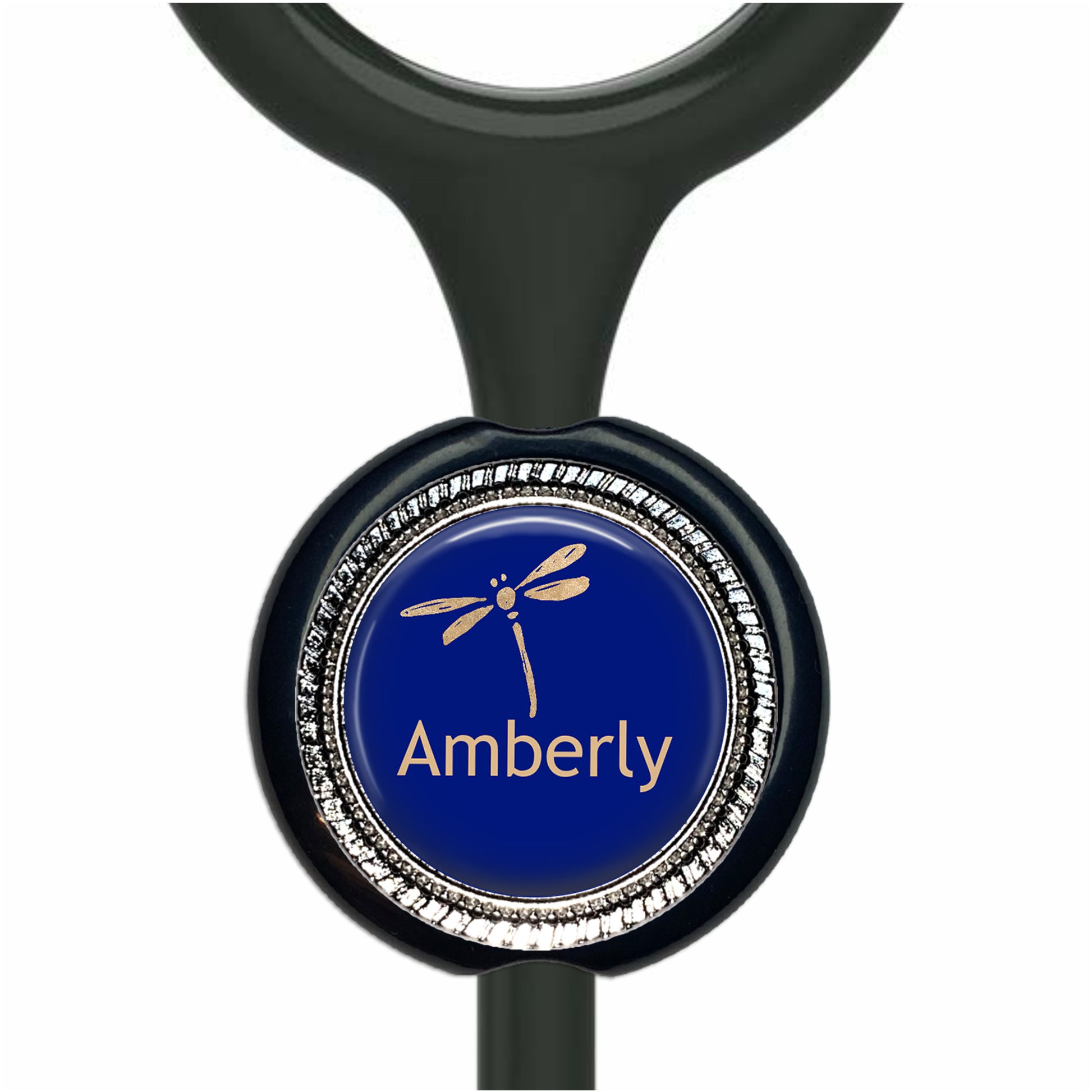 A blue circular badge with a gold dragonfly design, featuring the name "Amberly" written on it.