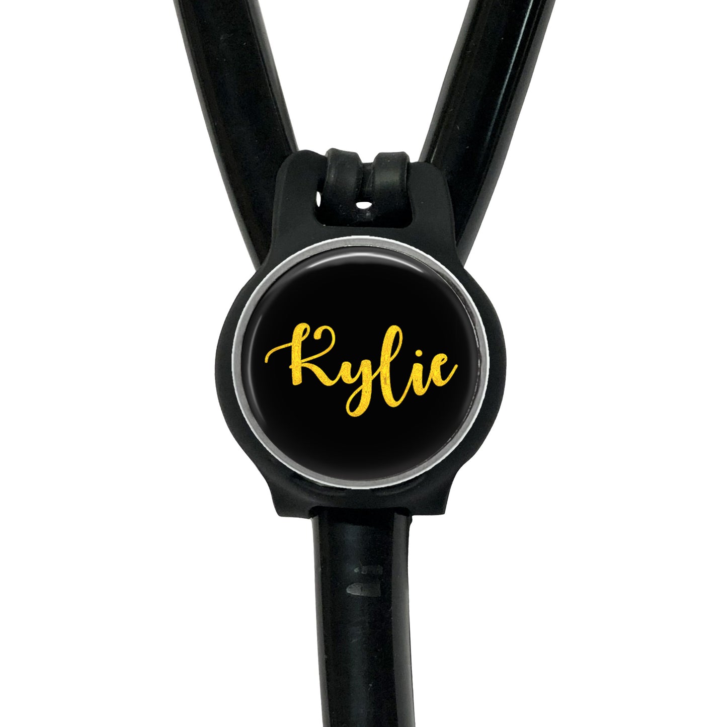 A black stethoscope with a round black button on the handle, displaying the name " Kylie" in yellow cursive font.