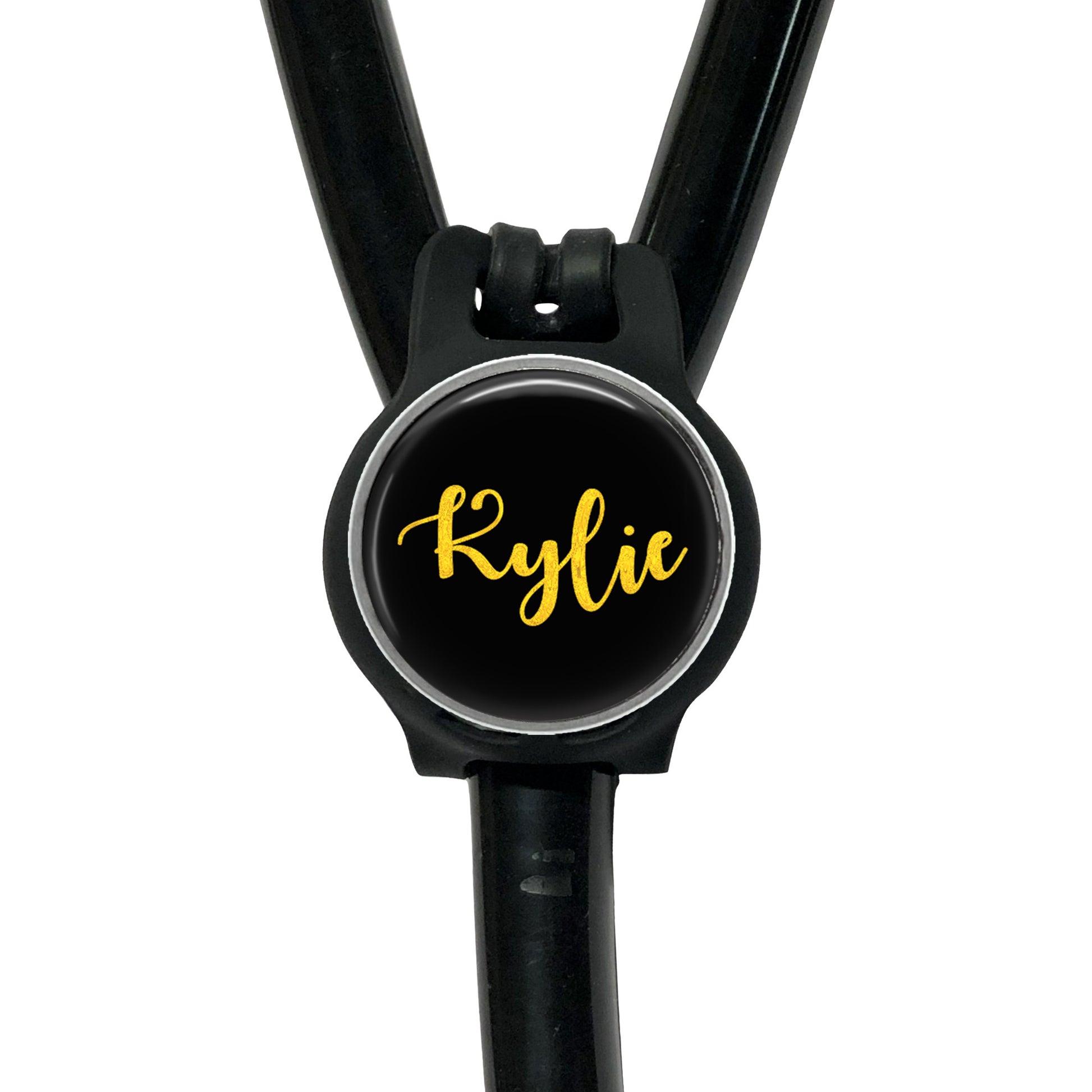 A black stethoscope with a round black button on the handle, displaying the name " Kylie" in yellow cursive font.