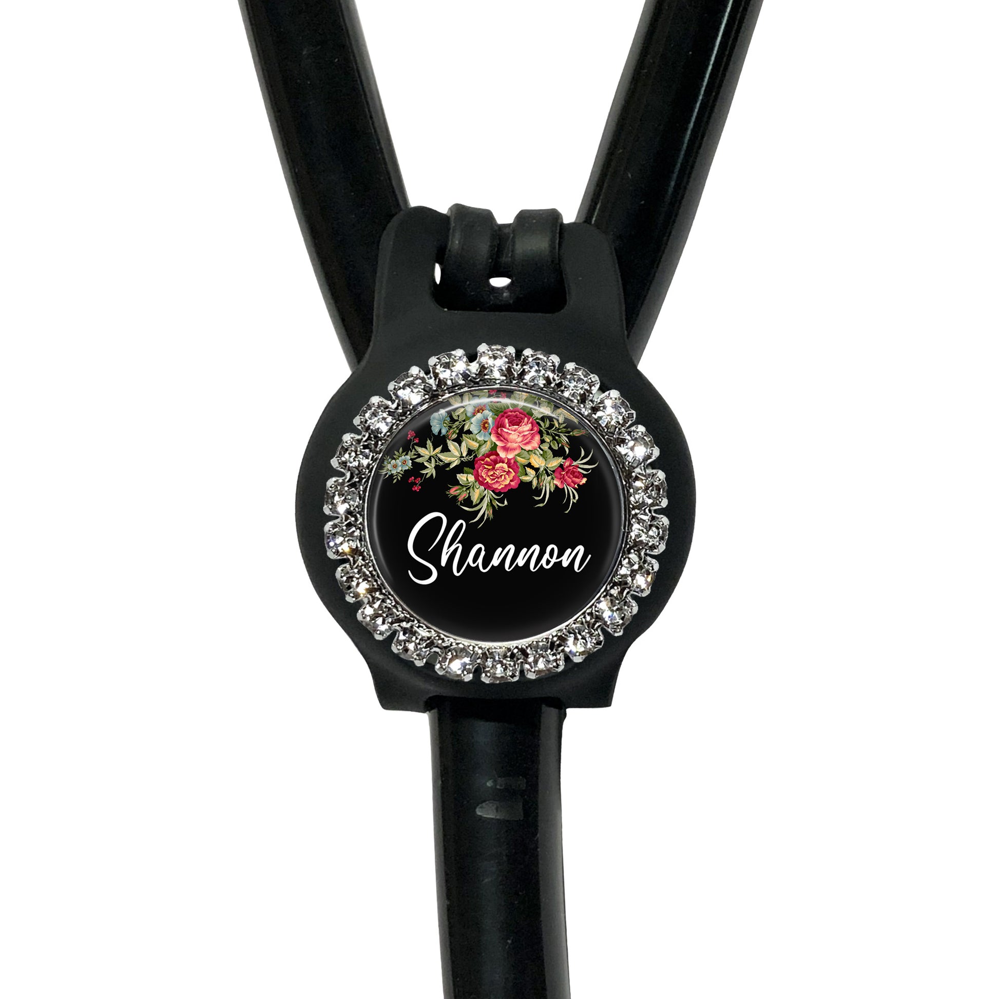 A black stethoscope with a personalized name badge attached to it.