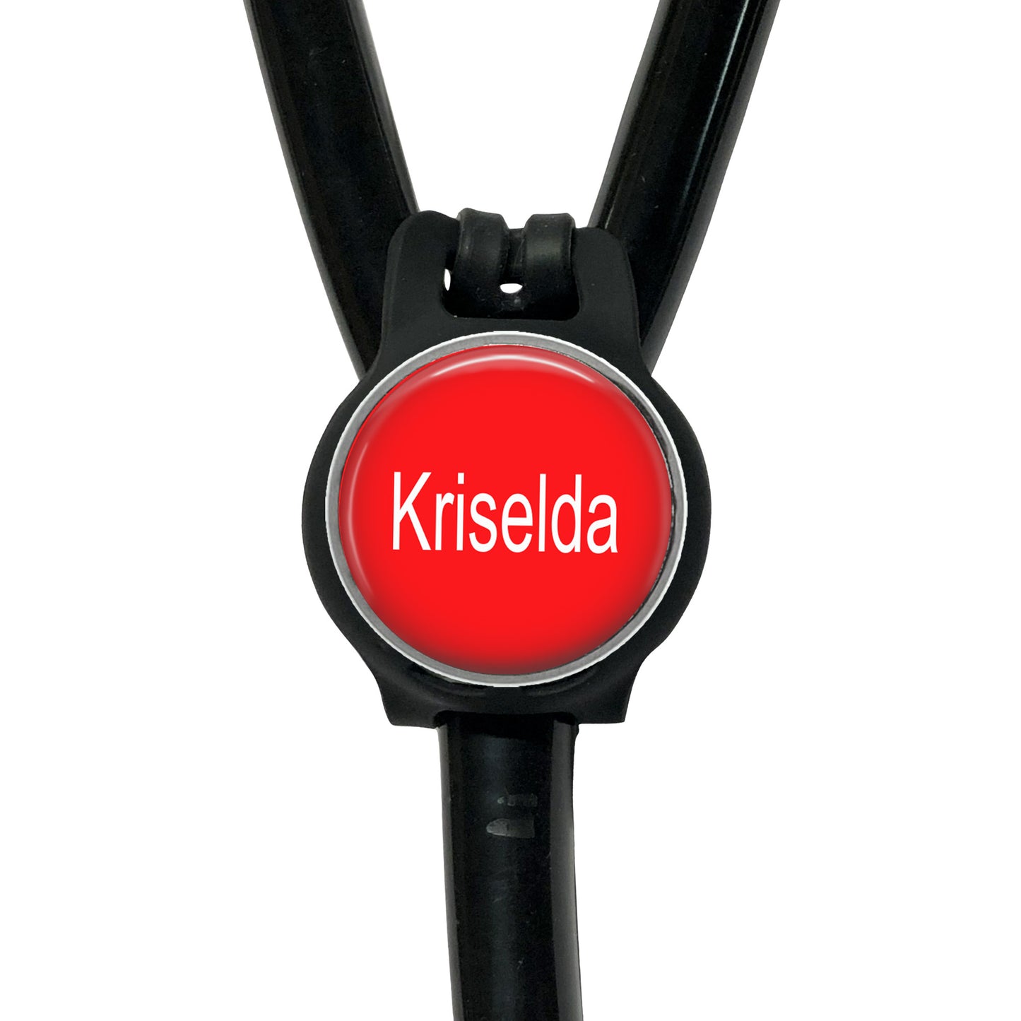 A red circular badge with the name "Krisela" written on it, attached to a black stethoscope.