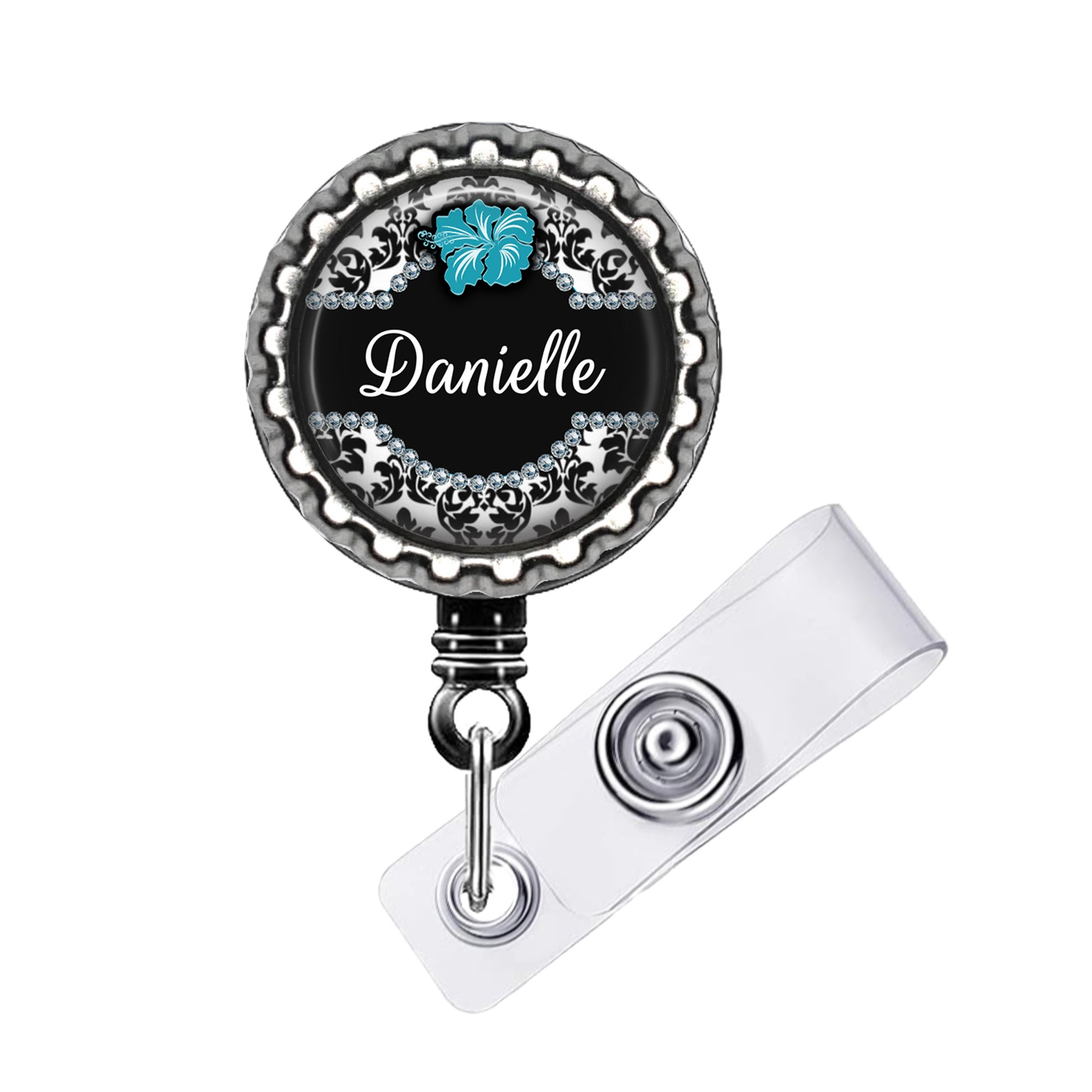A black and silver badge holder with a name tag attached to it.