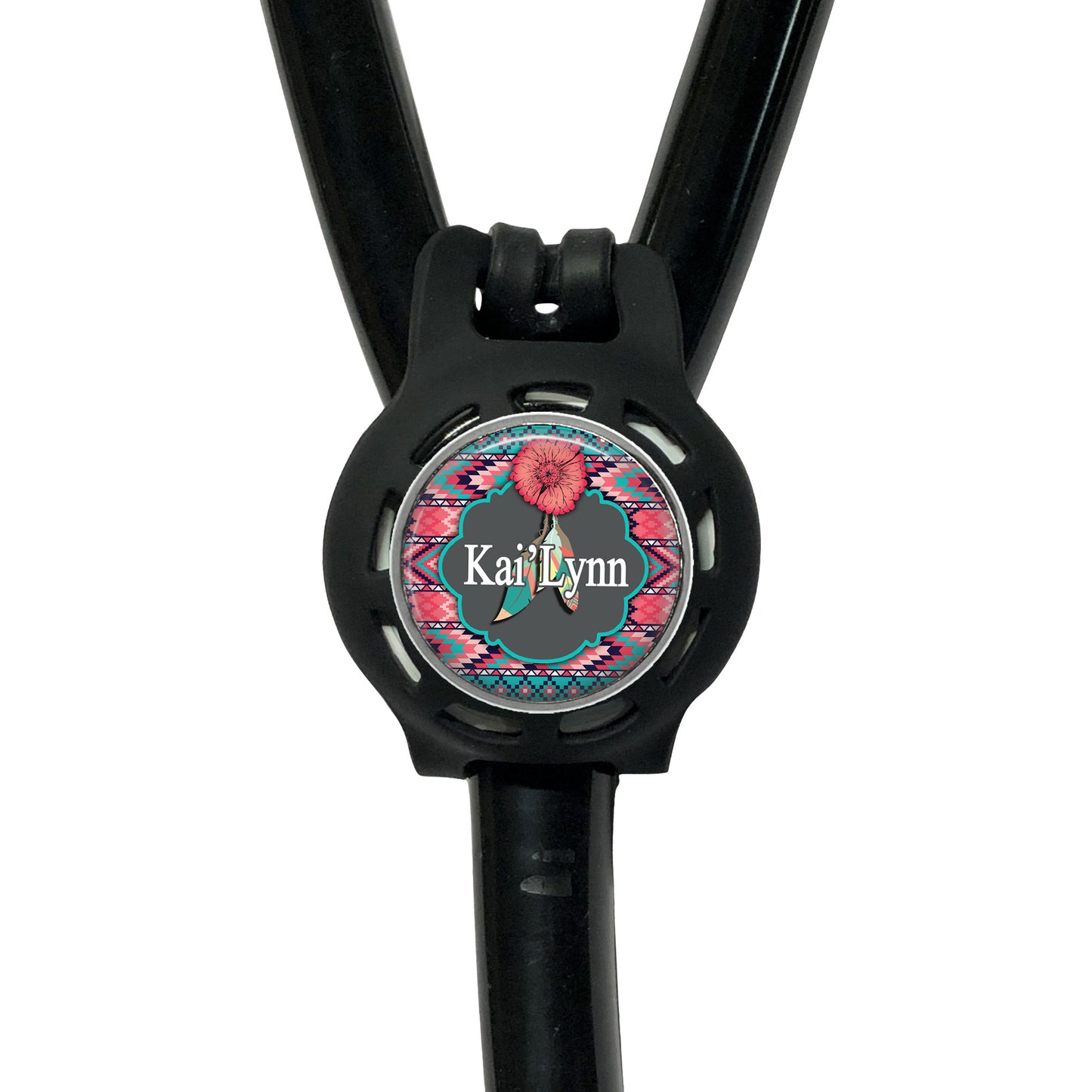 A black stethoscope with a personalized name badge attached to it.