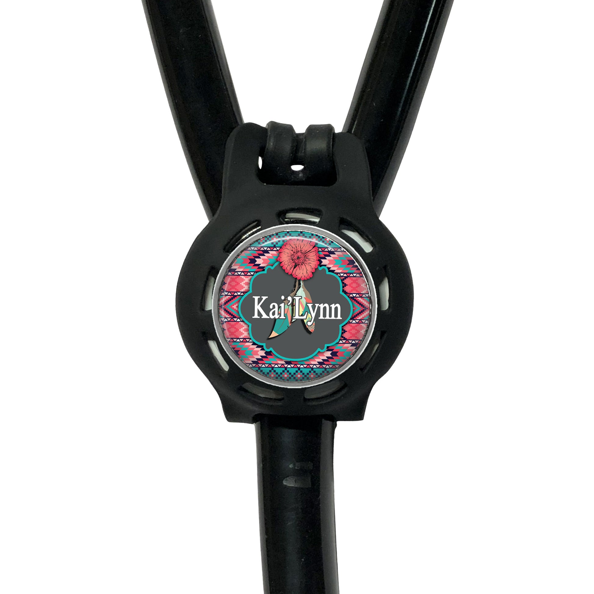 A black stethoscope with a personalized name badge attached to it.