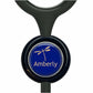 A blue button with a dragonfly design, featuring the word "Amberly" written on it.
