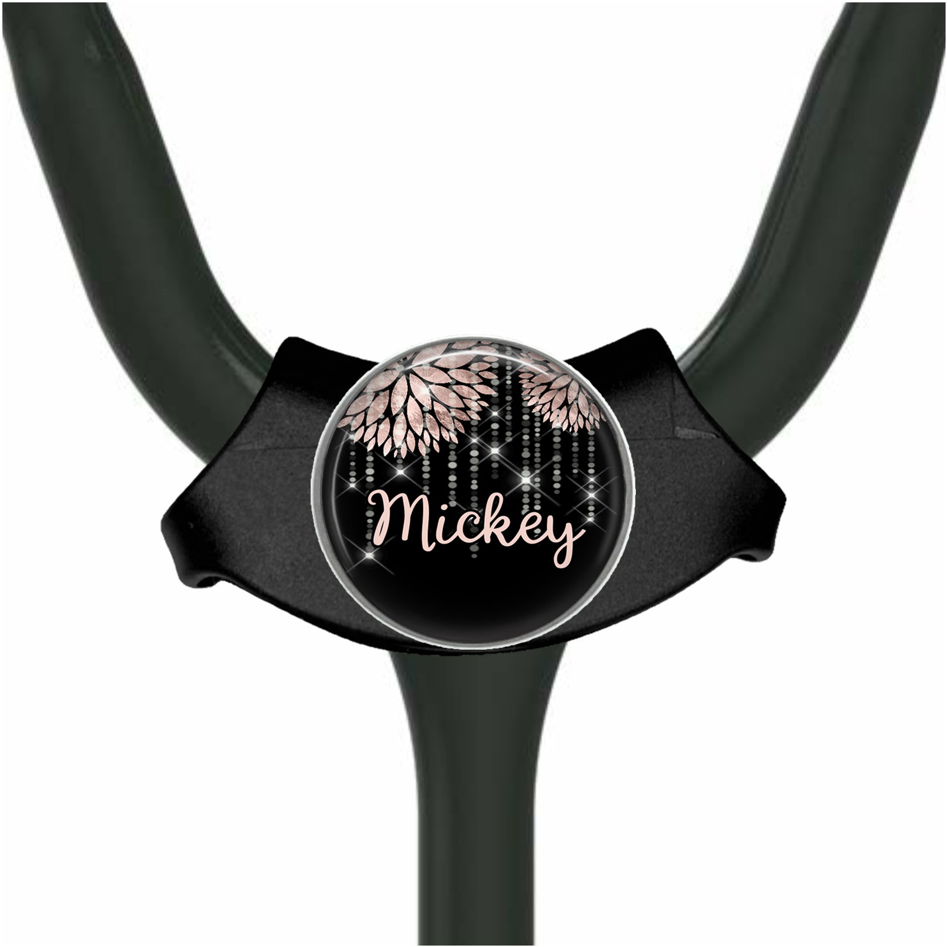 A black stethoscope with a personalized name badge attached to it.