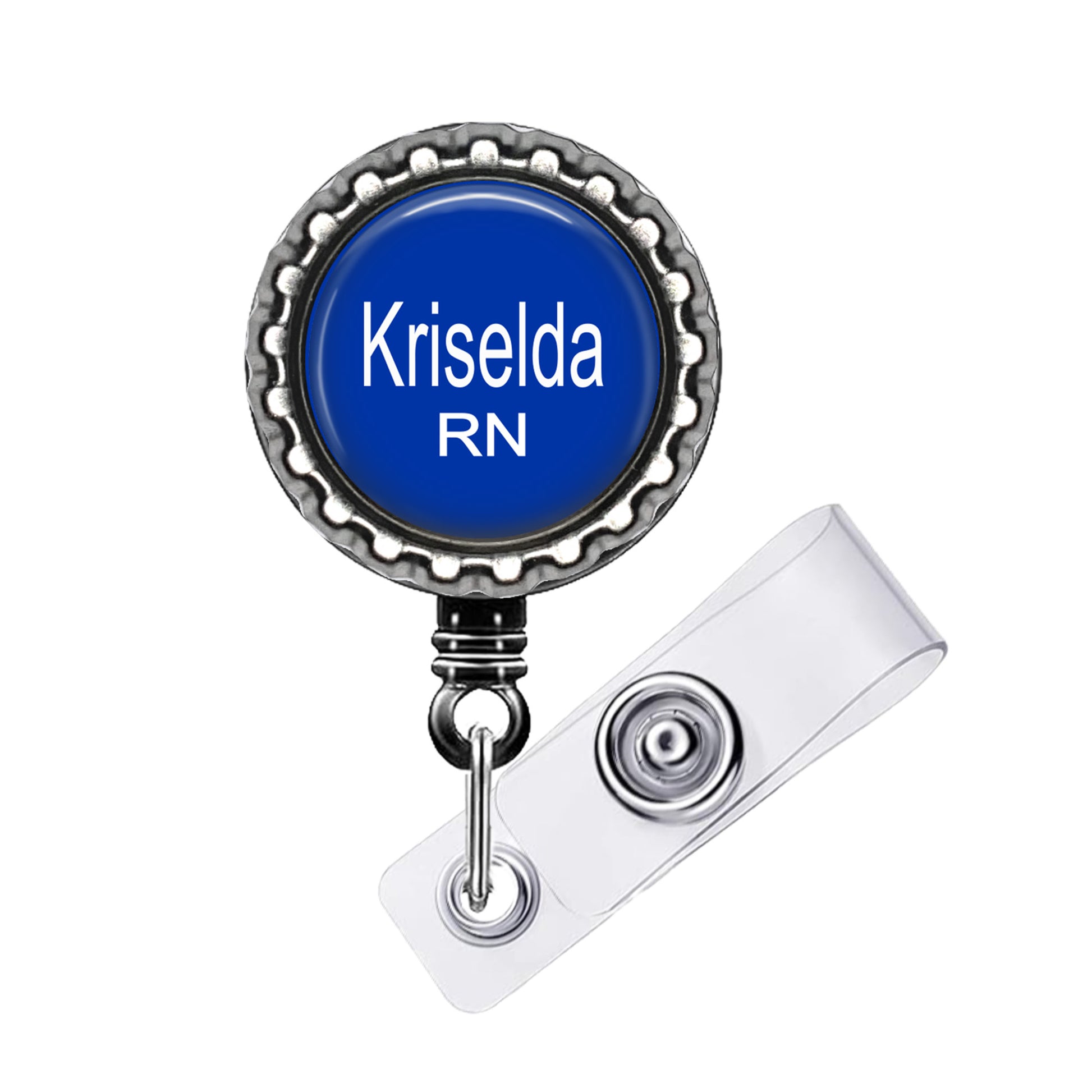 A blue badge with the name "Krisela RN" printed on it, attached to a metal clip.