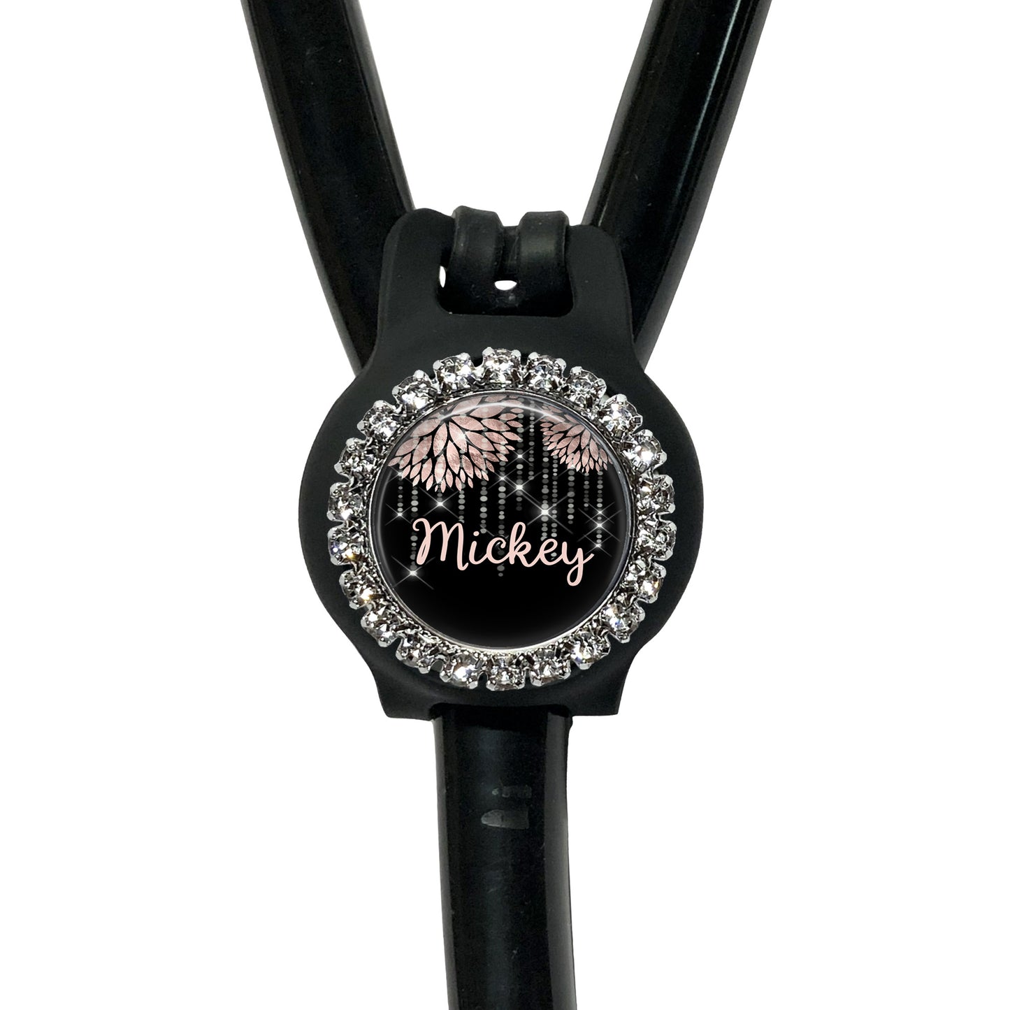 A black stethoscope with a personalized name badge attached to it.