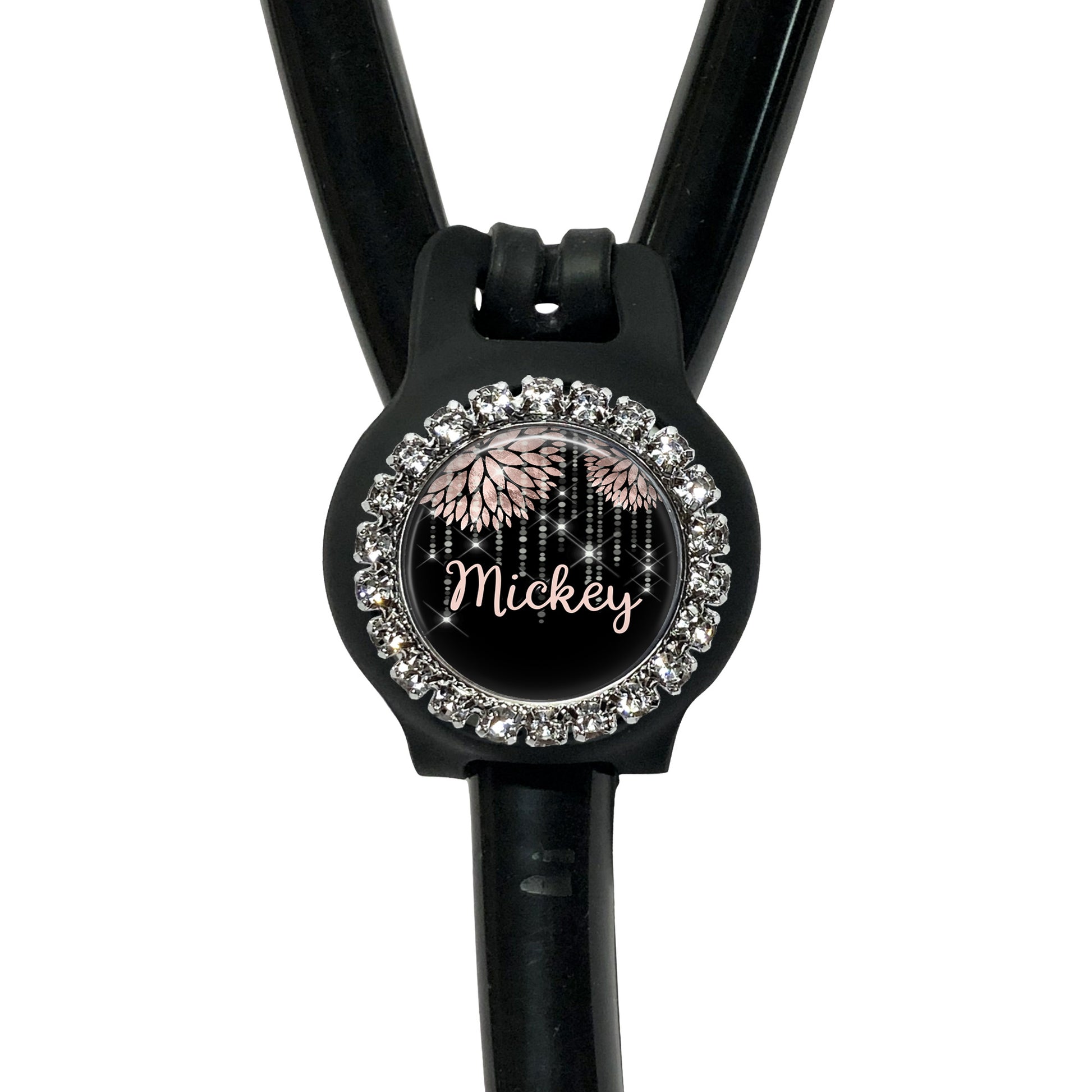 A black stethoscope with a personalized name badge attached to it.