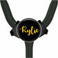 A black stethoscope with a personalized name badge attached to it.