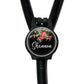 A black stethoscope with a personalized name badge attached to it.