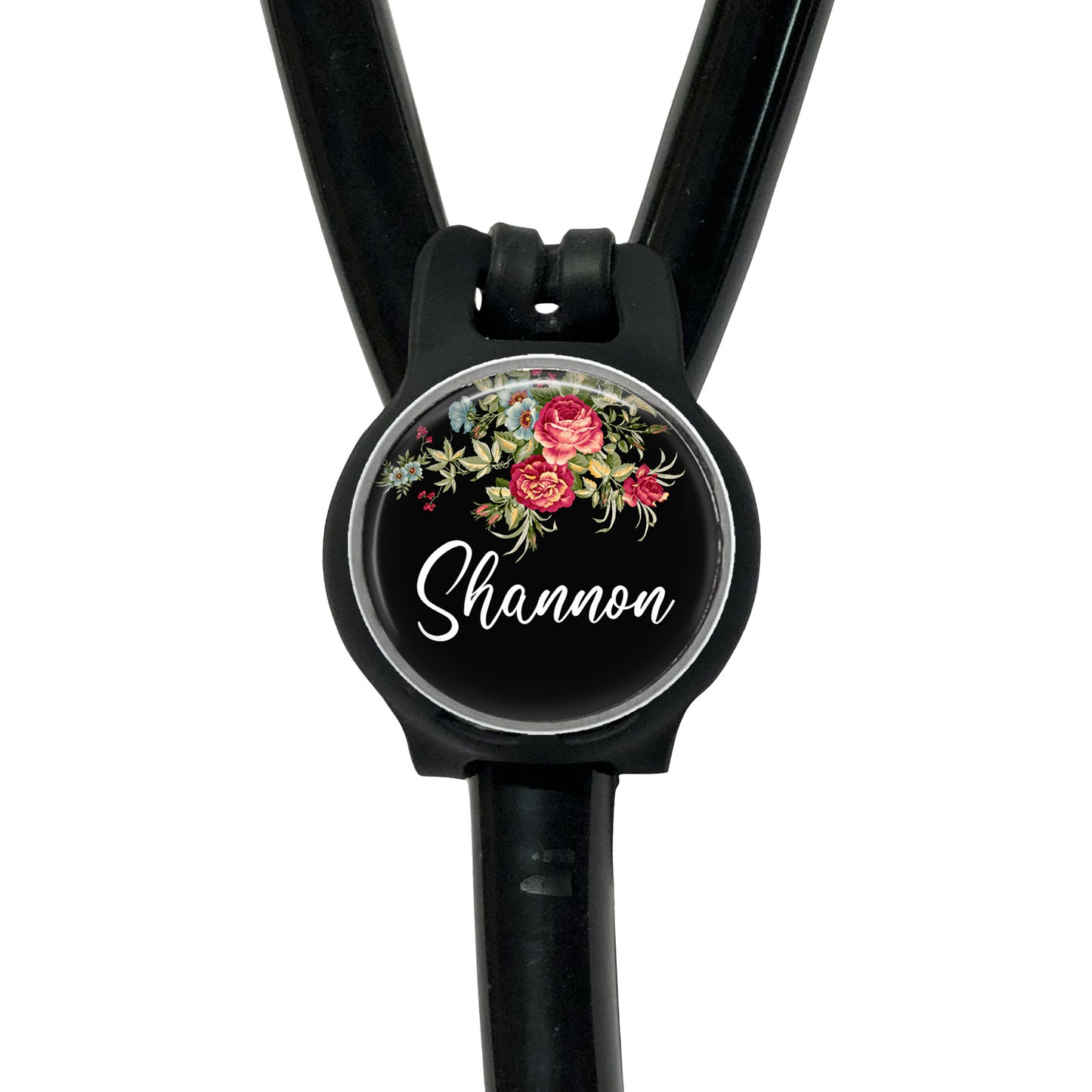 A black stethoscope with a personalized name badge attached to it.