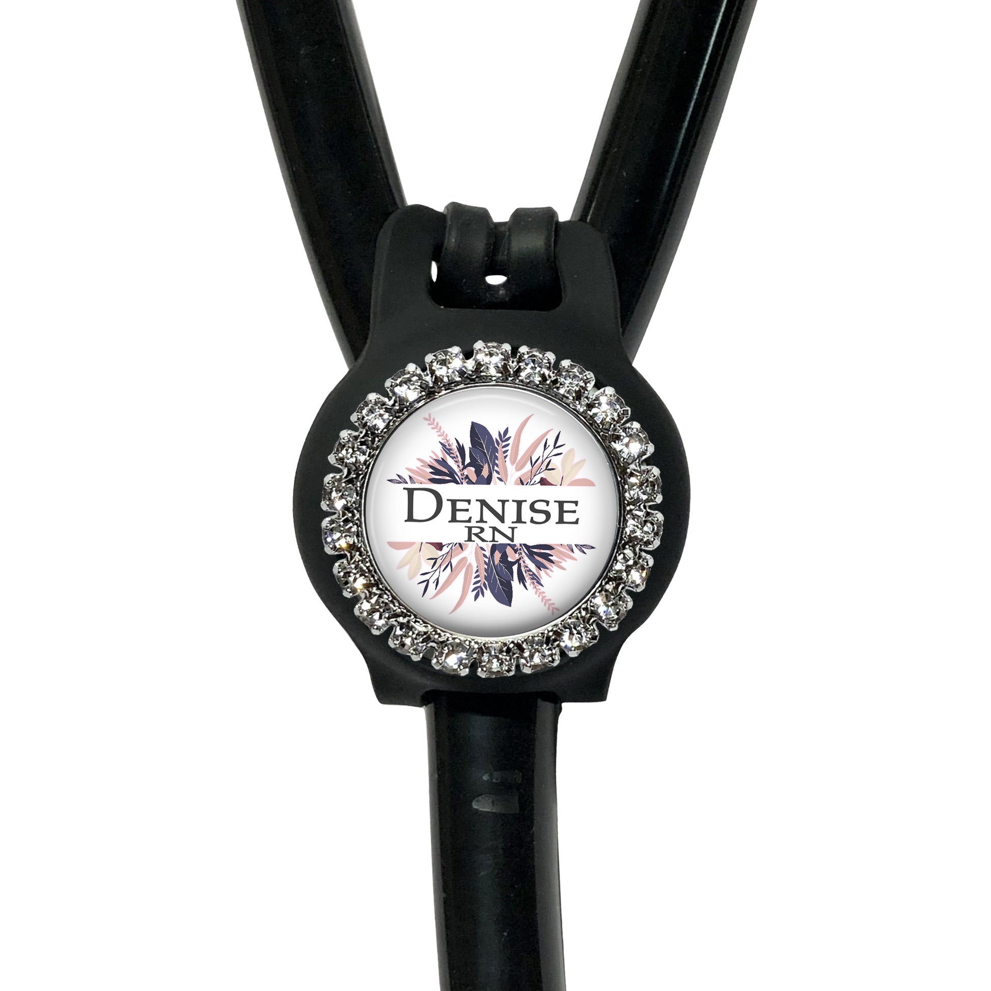 A black stethoscope with a decorative rhinestone-encrusted circular badge featuring the text "Denise RN" on it.