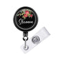 A black badge holder with a floral design and the name "Shannon" written on it.