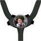A young boy wearing a helmet is smiling at the camera, with a round mirror or circular object in front of him.