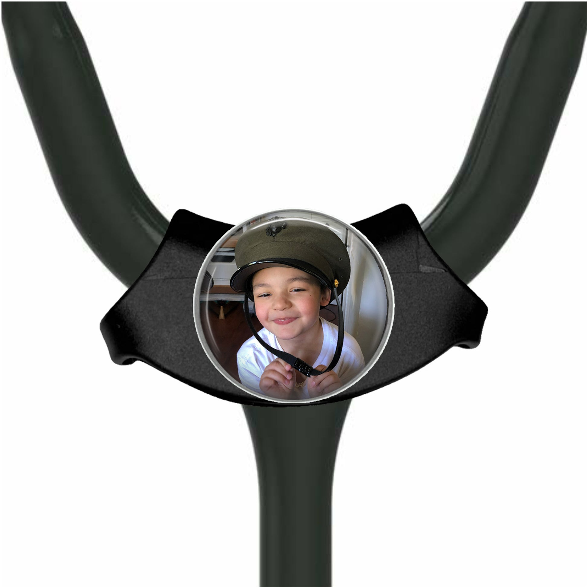 A young boy wearing a helmet is smiling at the camera, with a round mirror or circular object in front of him.