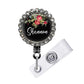 A black lanyard with a floral design and a name tag attached to it.