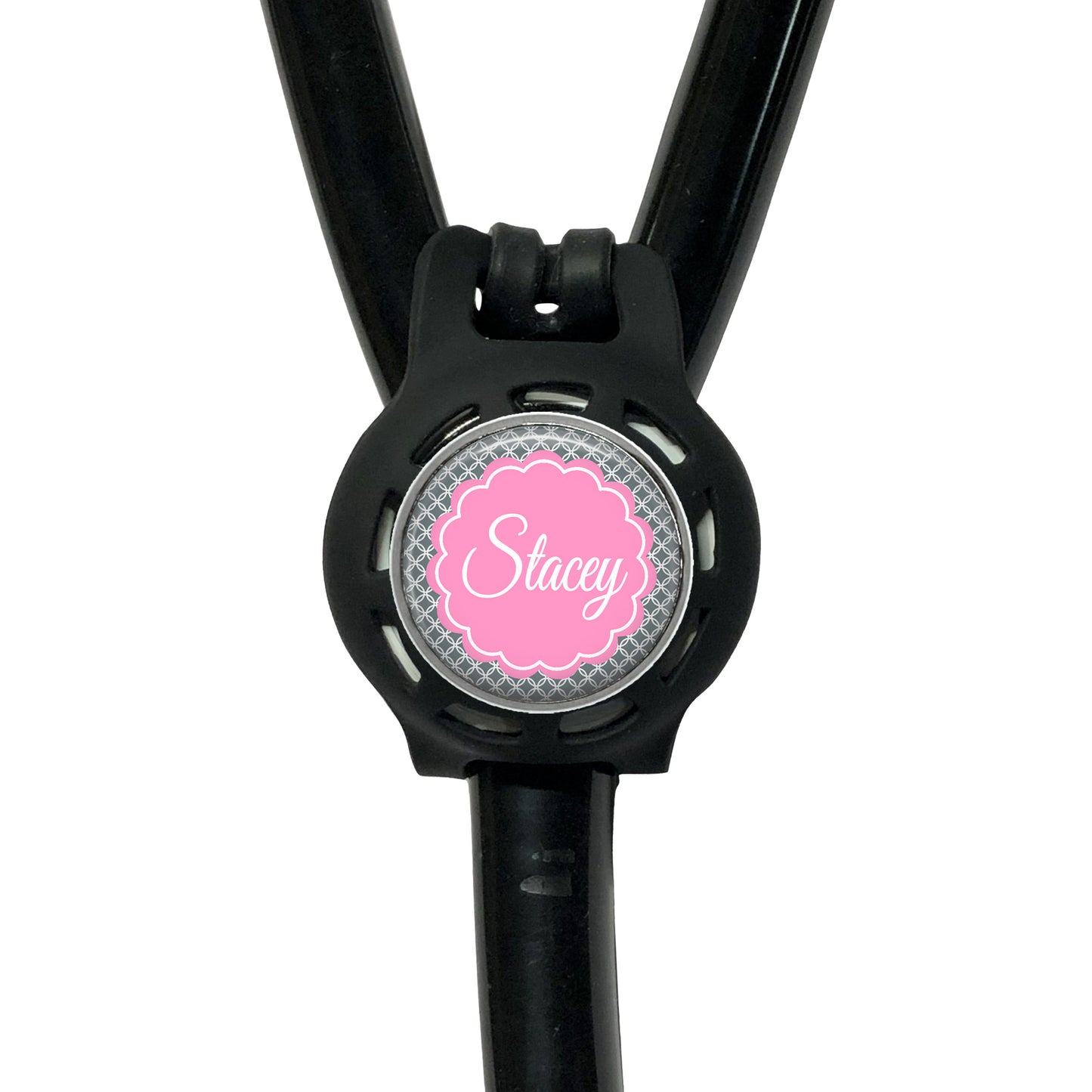 A black stethoscope with a personalized name badge attached to it.