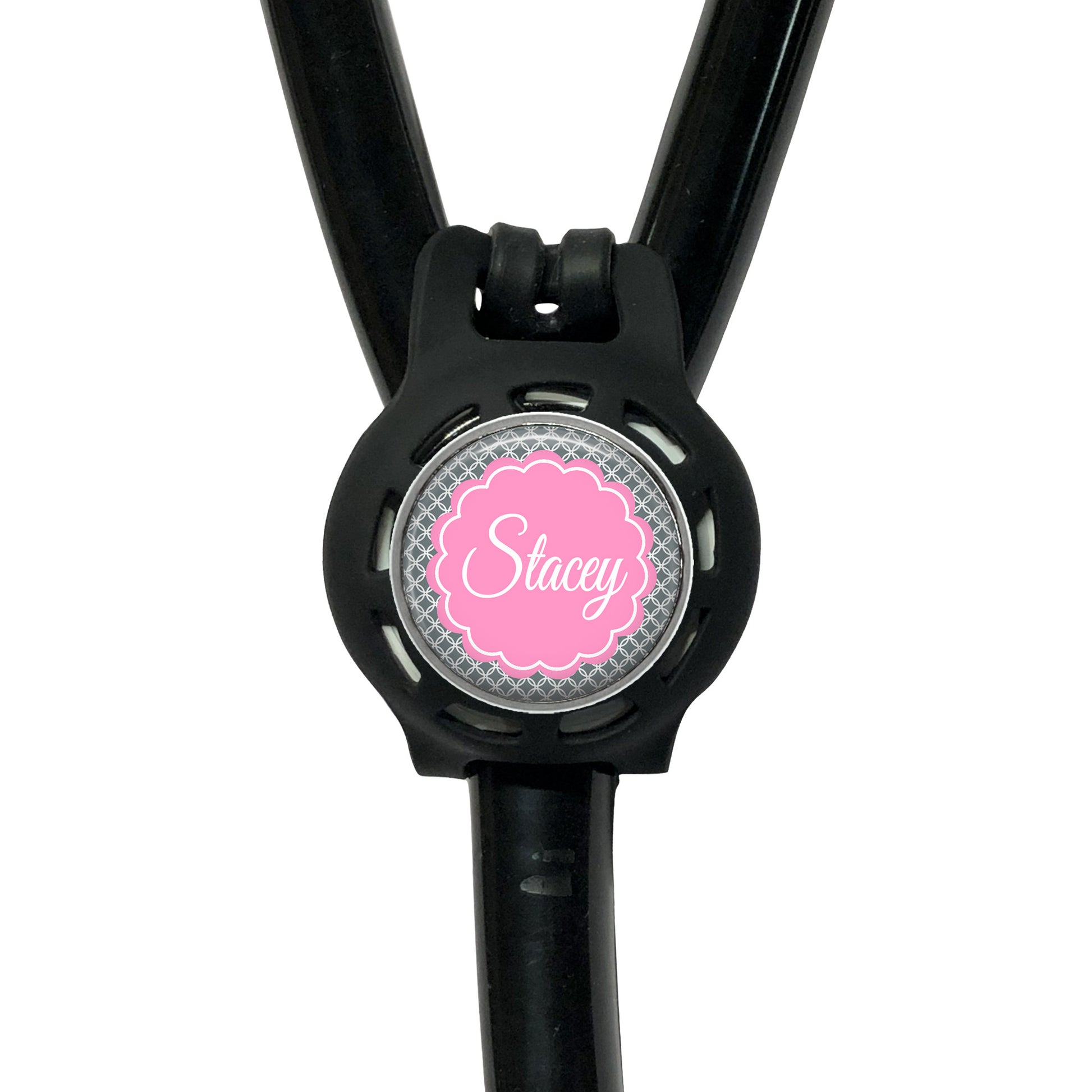 A black stethoscope with a personalized name badge attached to it.
