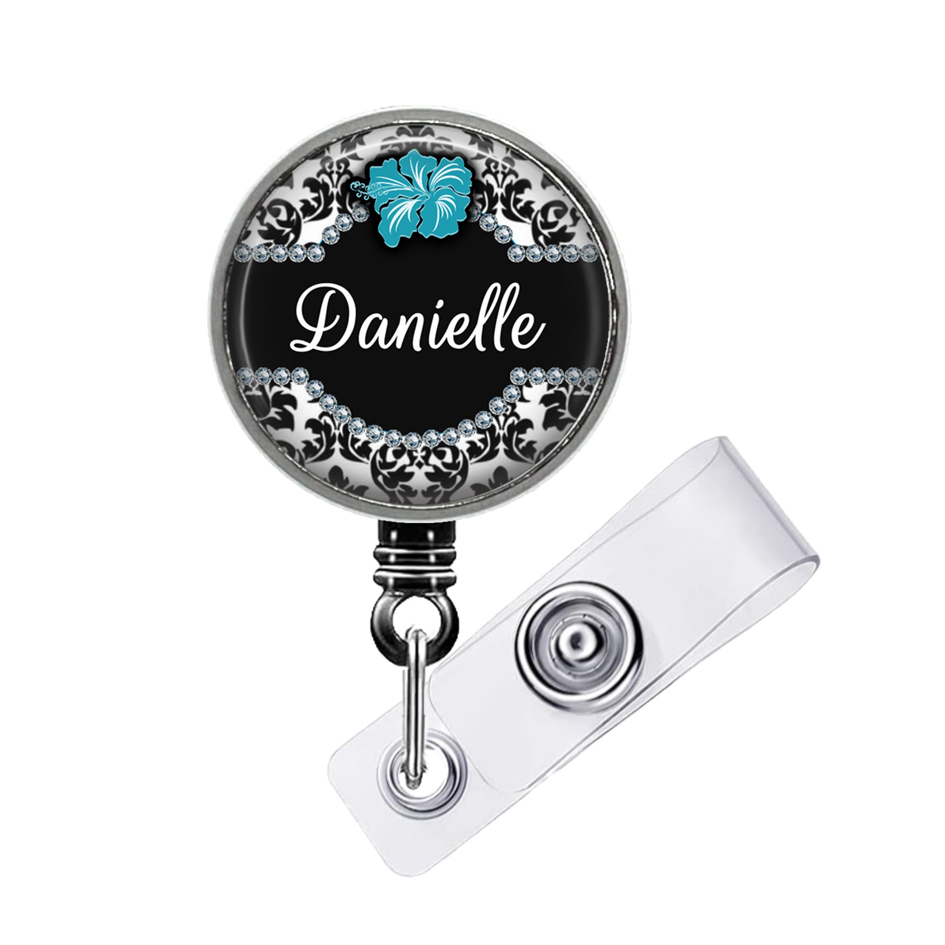 A black and silver badge holder with a name tag attached to it.