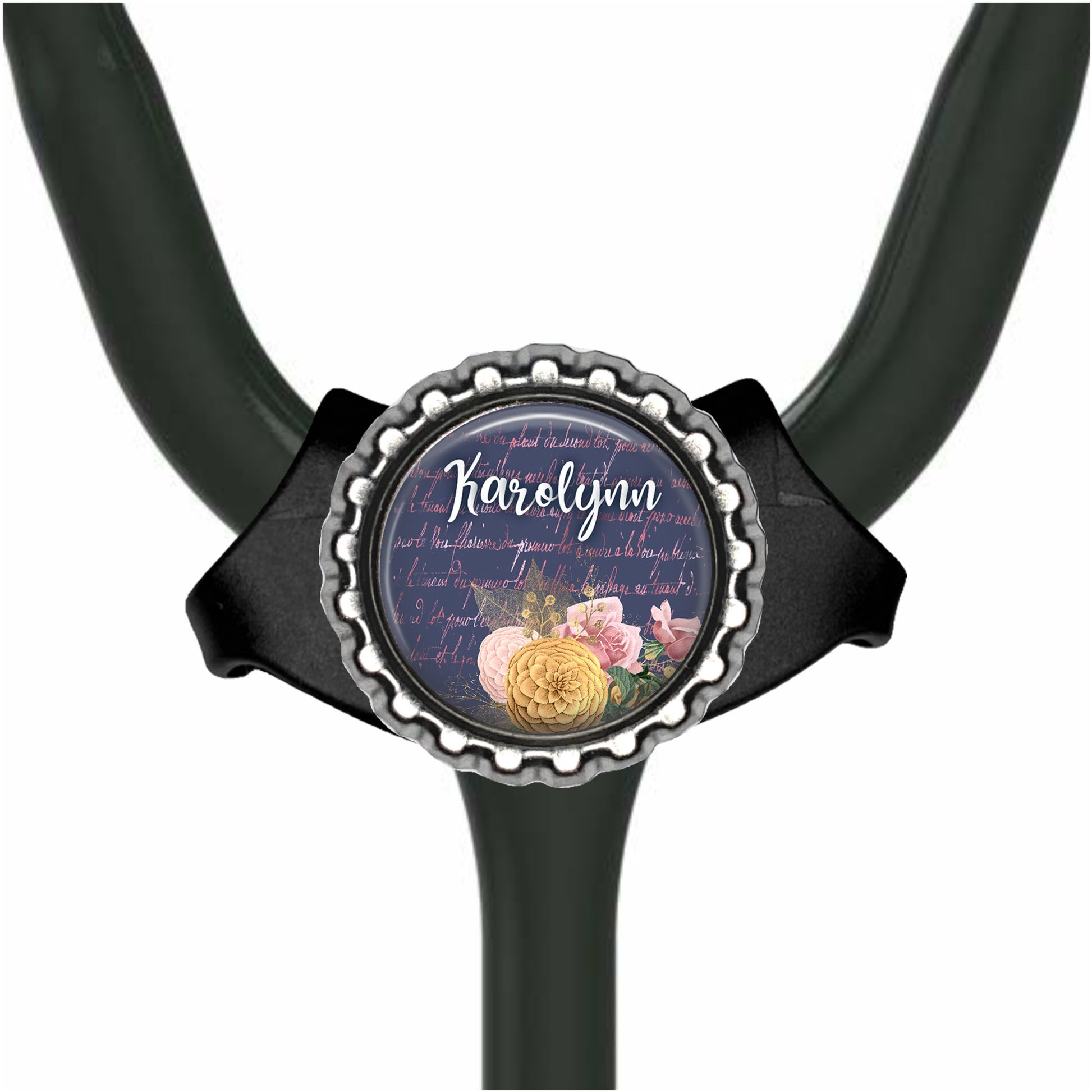 A black stethoscope with a round metal badge featuring a floral design and the name "Harold" written on it.