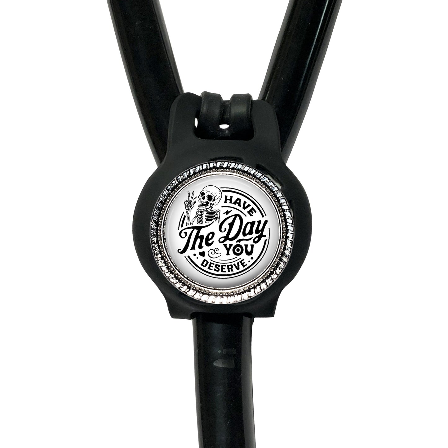 A black stethoscope with a circular badge on the handle that says "The Day You Deserve".