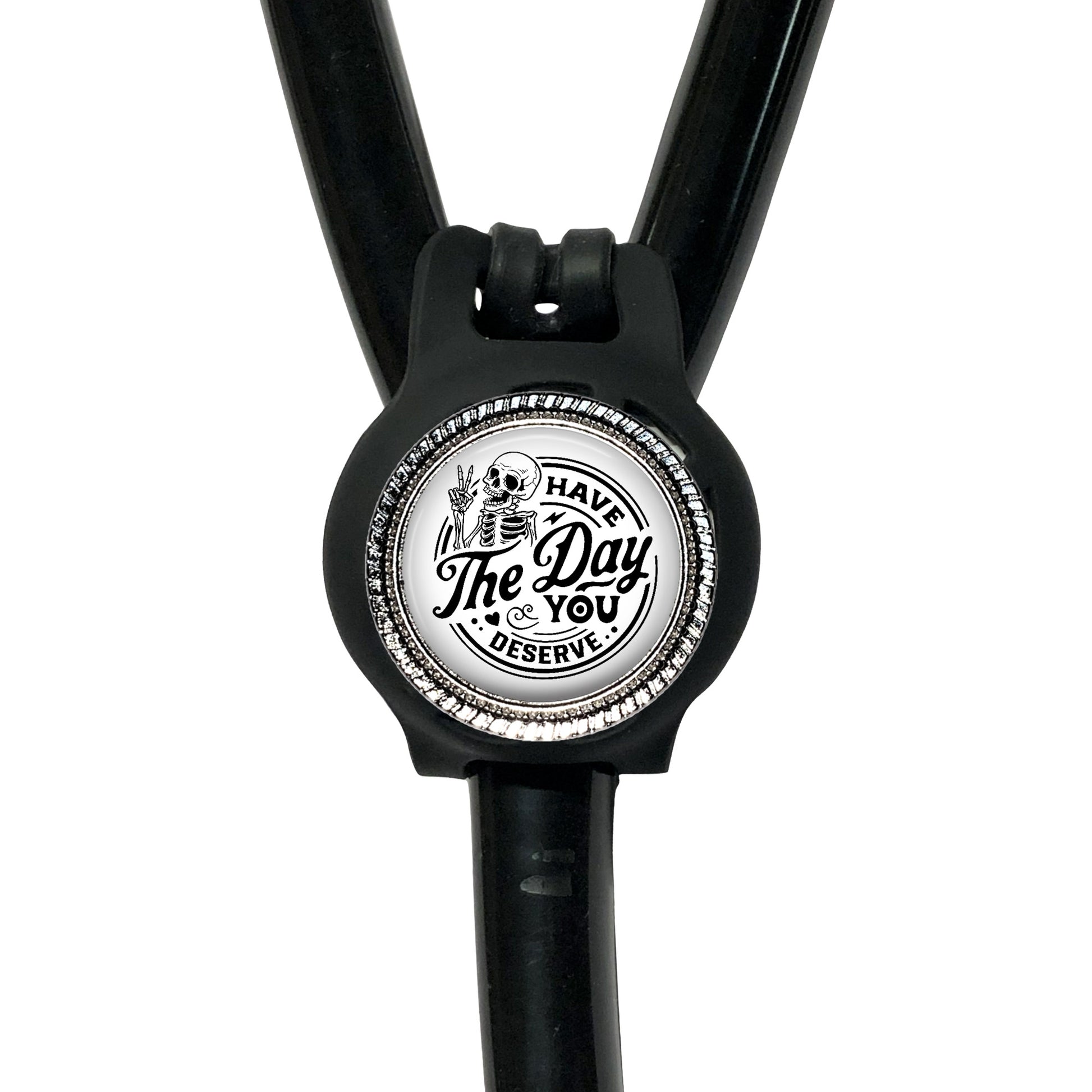 A black stethoscope with a circular badge on the handle that says "The Day You Deserve".