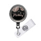 A black and silver badge holder with a personalized name tag attached.