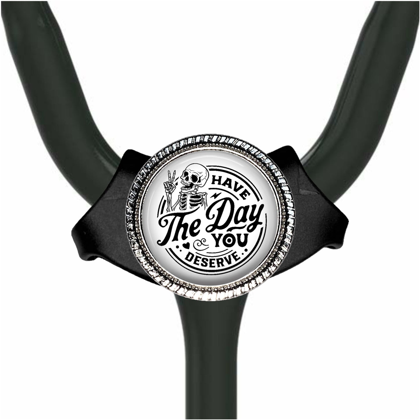 A black and white medical stethoscope with a decorative charm featuring a skeleton and the text "The Day You Deserve".