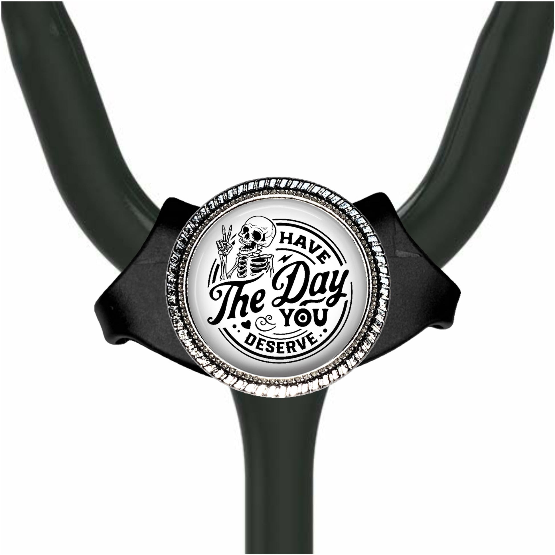 A black and white medical stethoscope with a decorative charm featuring a skeleton and the text "The Day You Deserve".