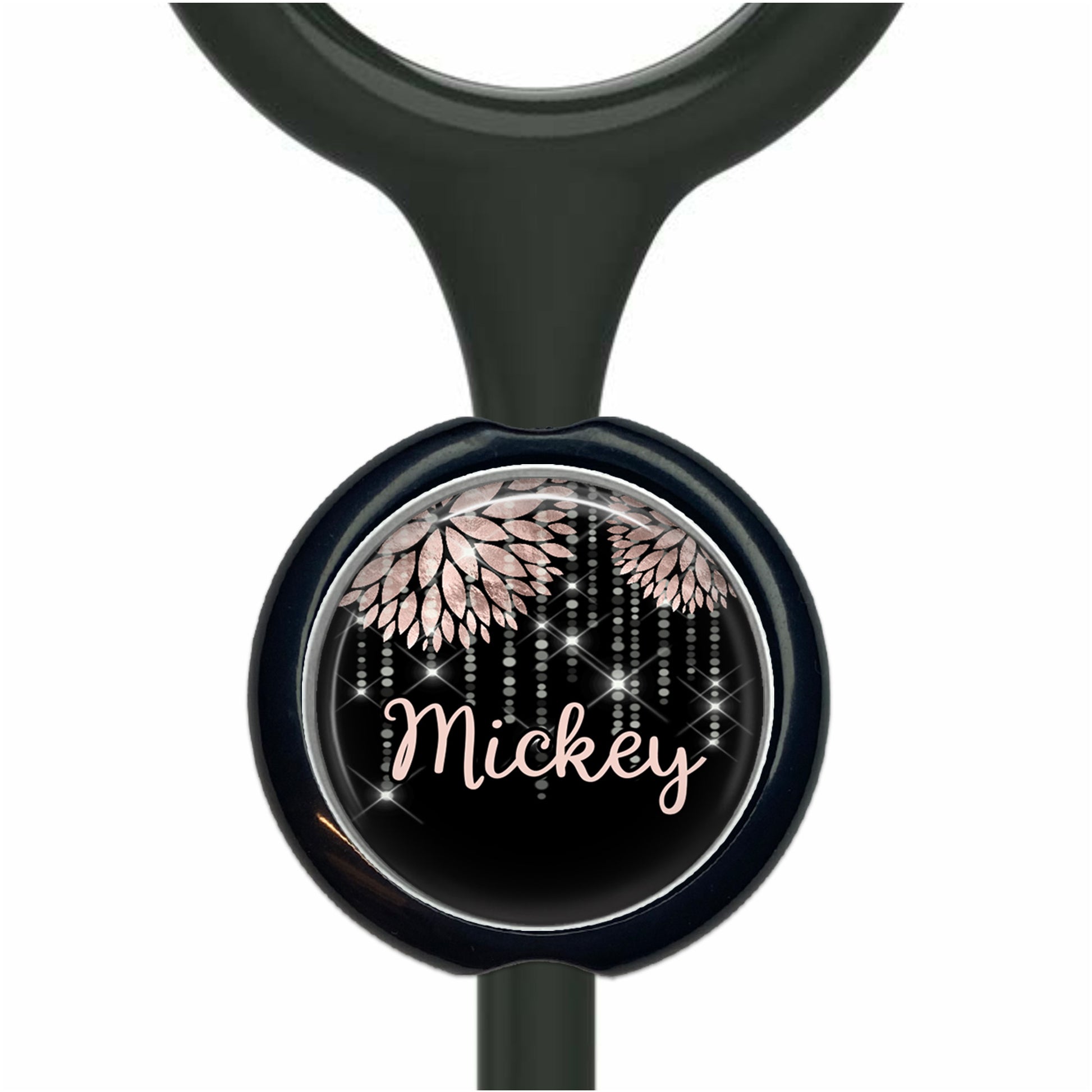 A black stethoscope with a round, black and white design featuring pink flowers and the name "Mickey" written on it.