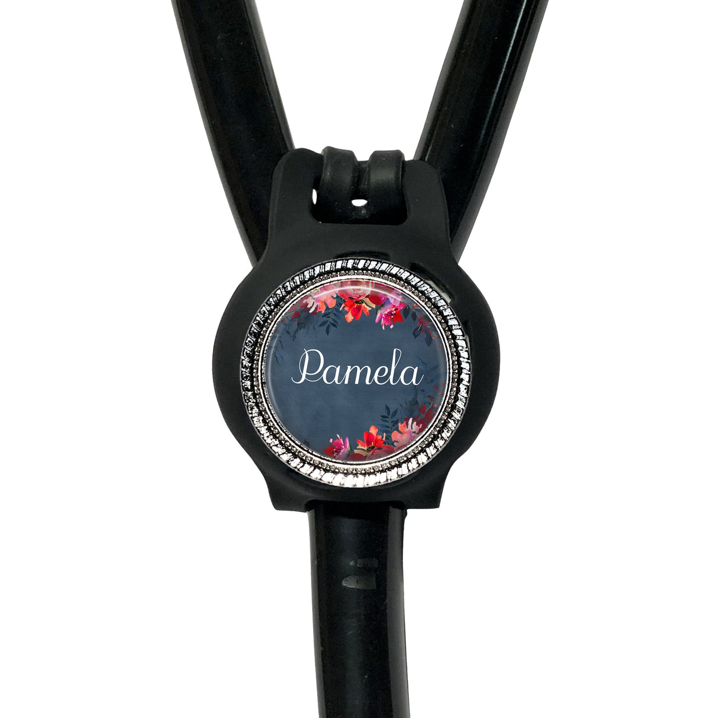A black stethoscope with a personalized name badge attached to it.