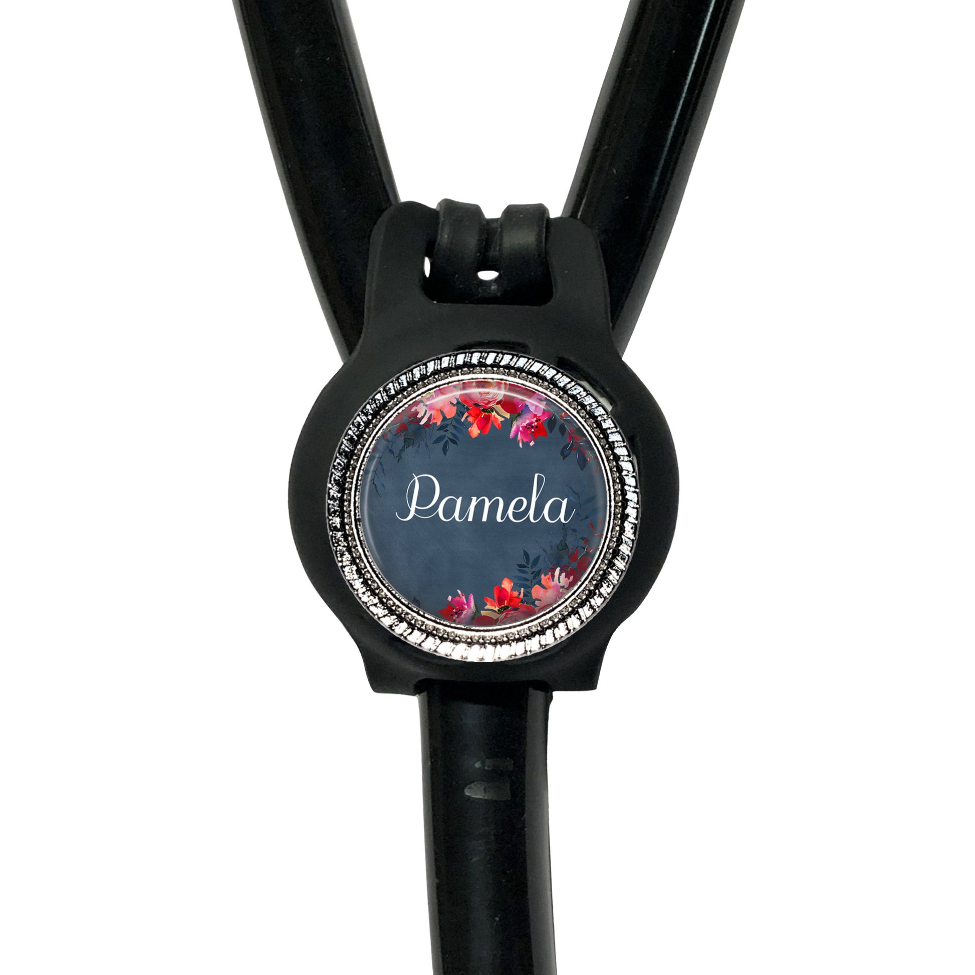 A black stethoscope with a personalized name badge attached to it.