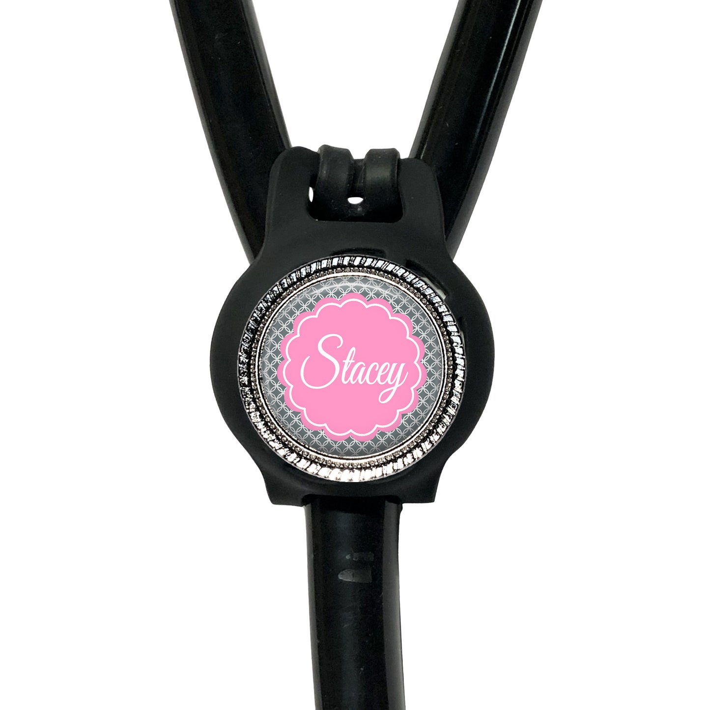 A black stethoscope with a personalized name badge attached to it.
