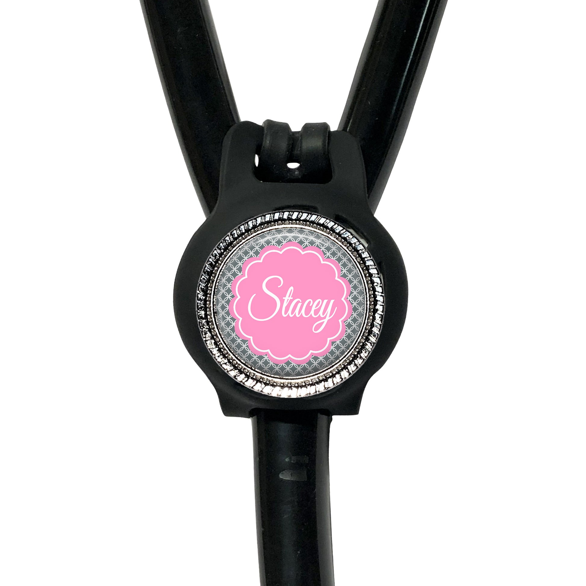 A black stethoscope with a personalized name badge attached to it.