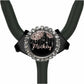 A black stethoscope with a round, ornate charm featuring the name "Mickey" and a floral design.