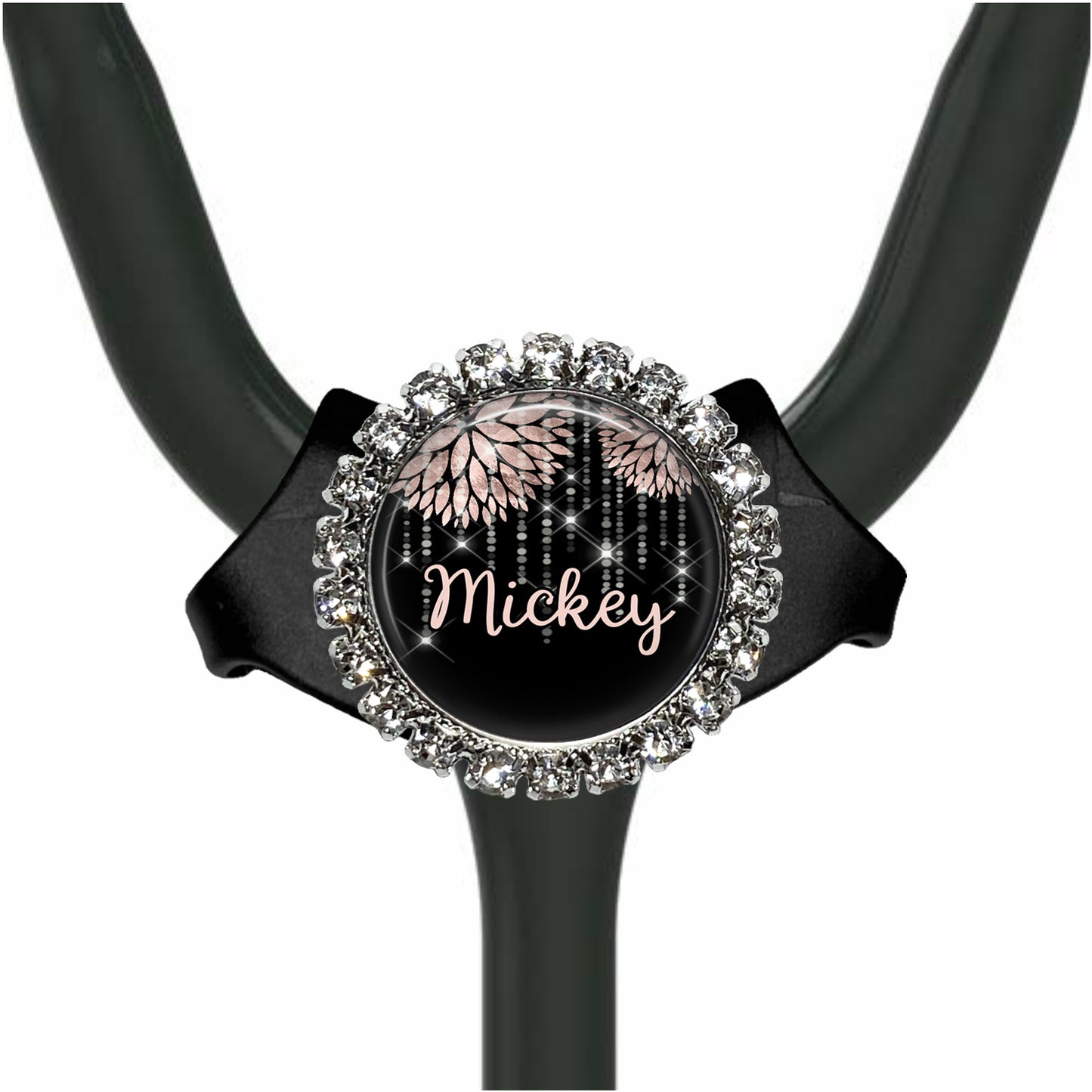 A black stethoscope with a round, ornate charm featuring the name "Mickey" and a floral design.