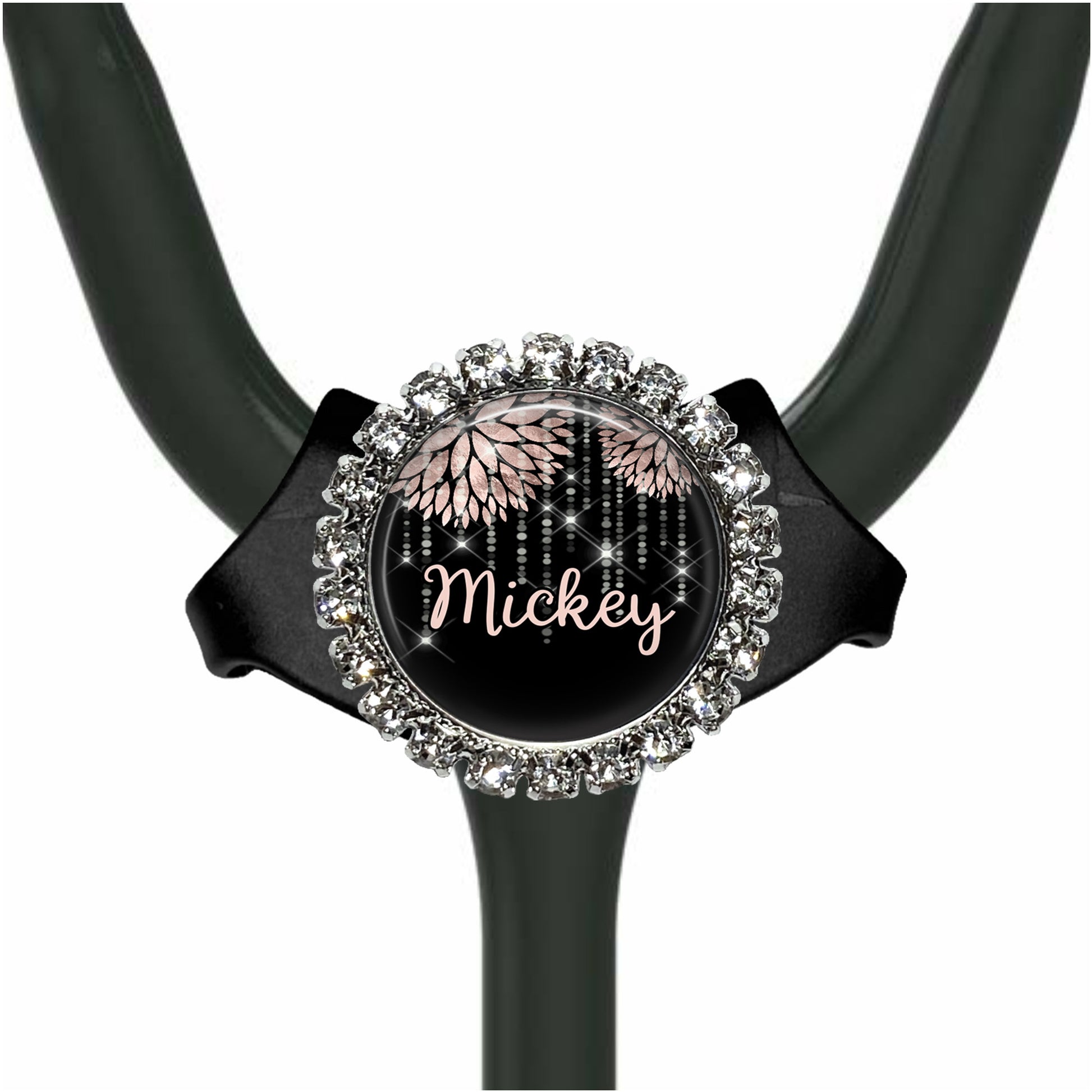 A black stethoscope with a round, ornate charm featuring the name "Mickey" and a floral design.