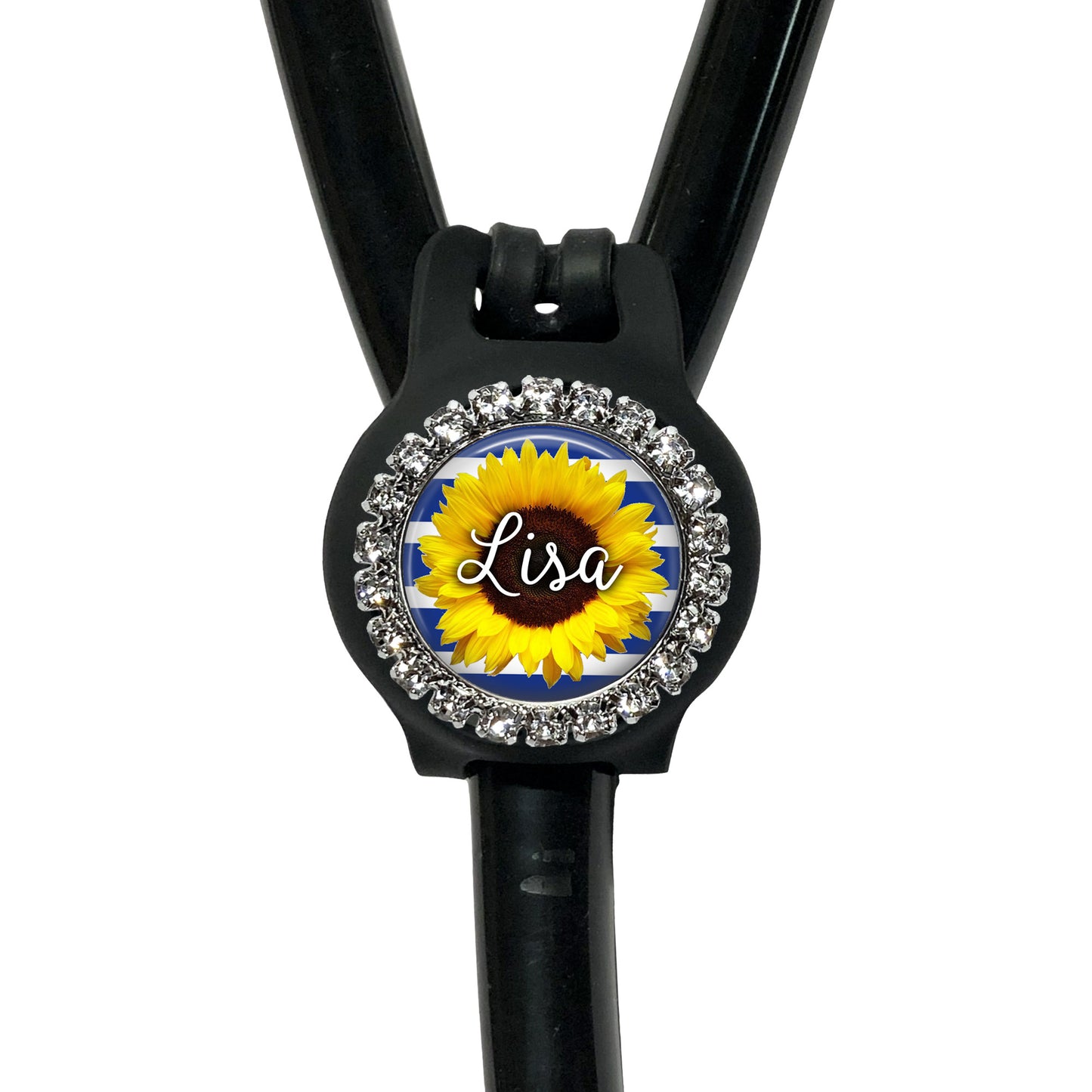 A black stethoscope with a personalized name badge attached to it. The name badge features a sunflower design and is decorated with rhinestones.