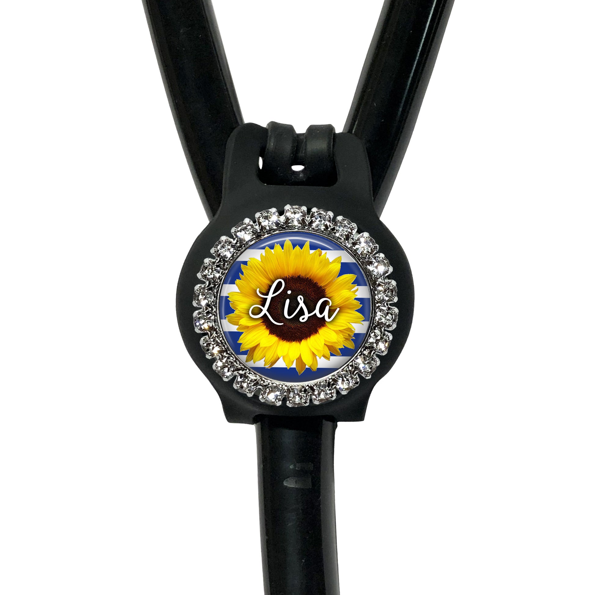 A black stethoscope with a personalized name badge attached to it. The name badge features a sunflower design and is decorated with rhinestones.