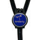 A blue circular badge with a dragonfly design, attached to a black strap or cord.