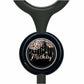 A black stethoscope with a round, black and white design featuring the name "Mickey" and a floral pattern.