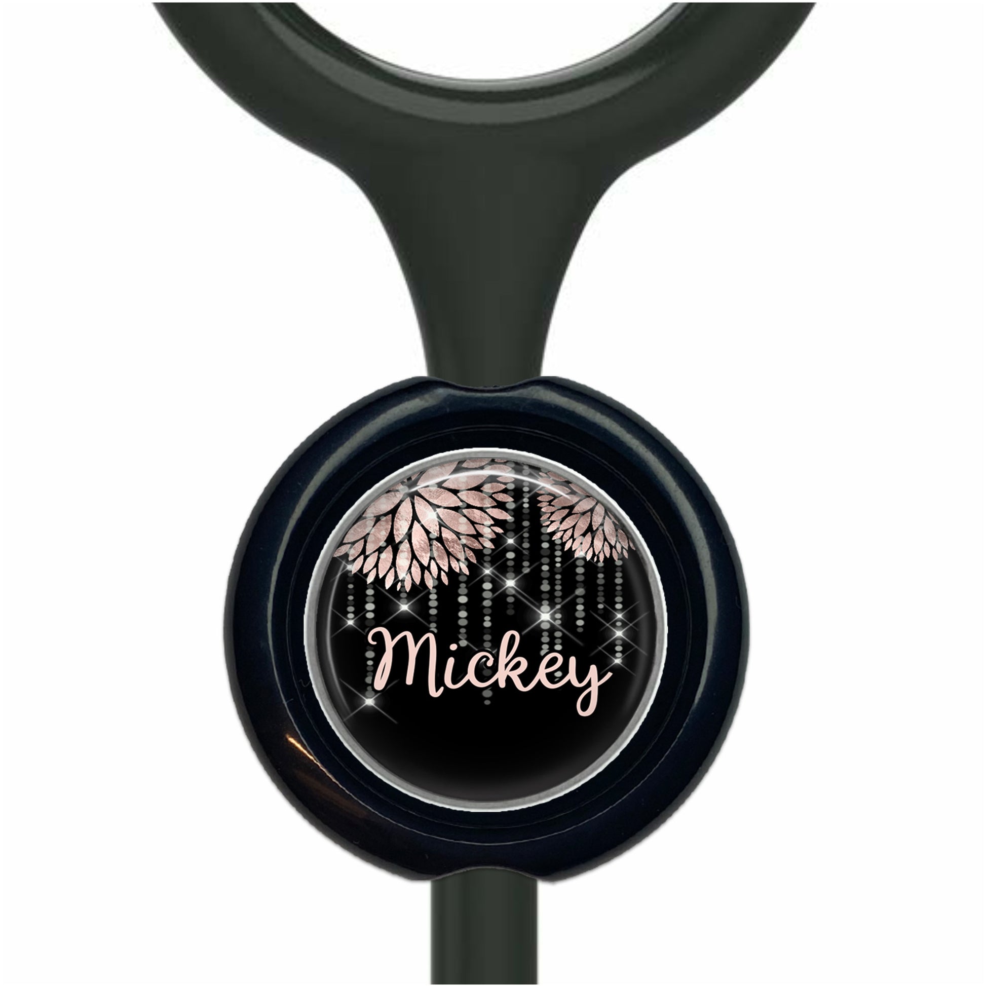 A black stethoscope with a round, black and white design featuring the name "Mickey" and a floral pattern.