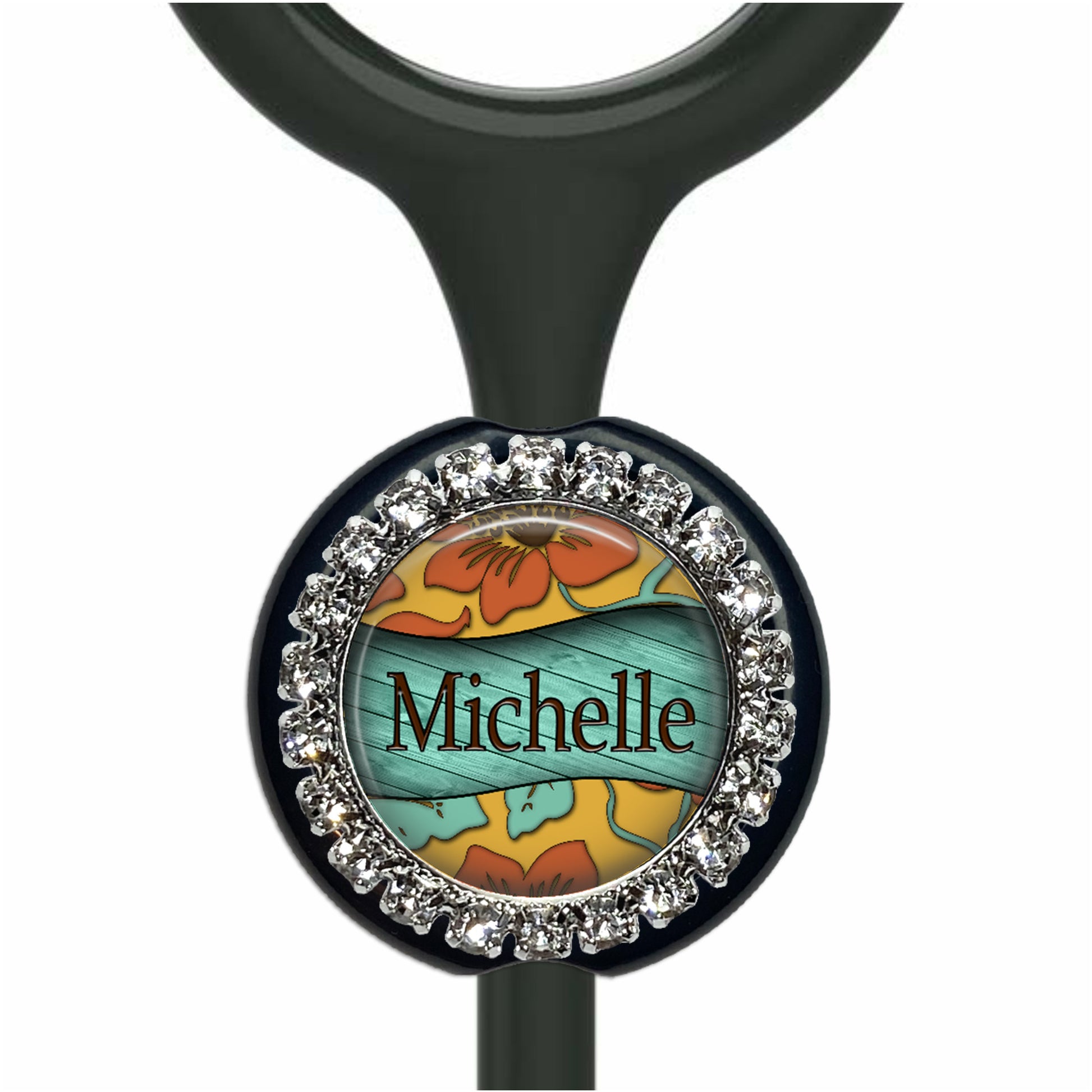A personalized nameplate with a floral design and rhinestones around the edge.