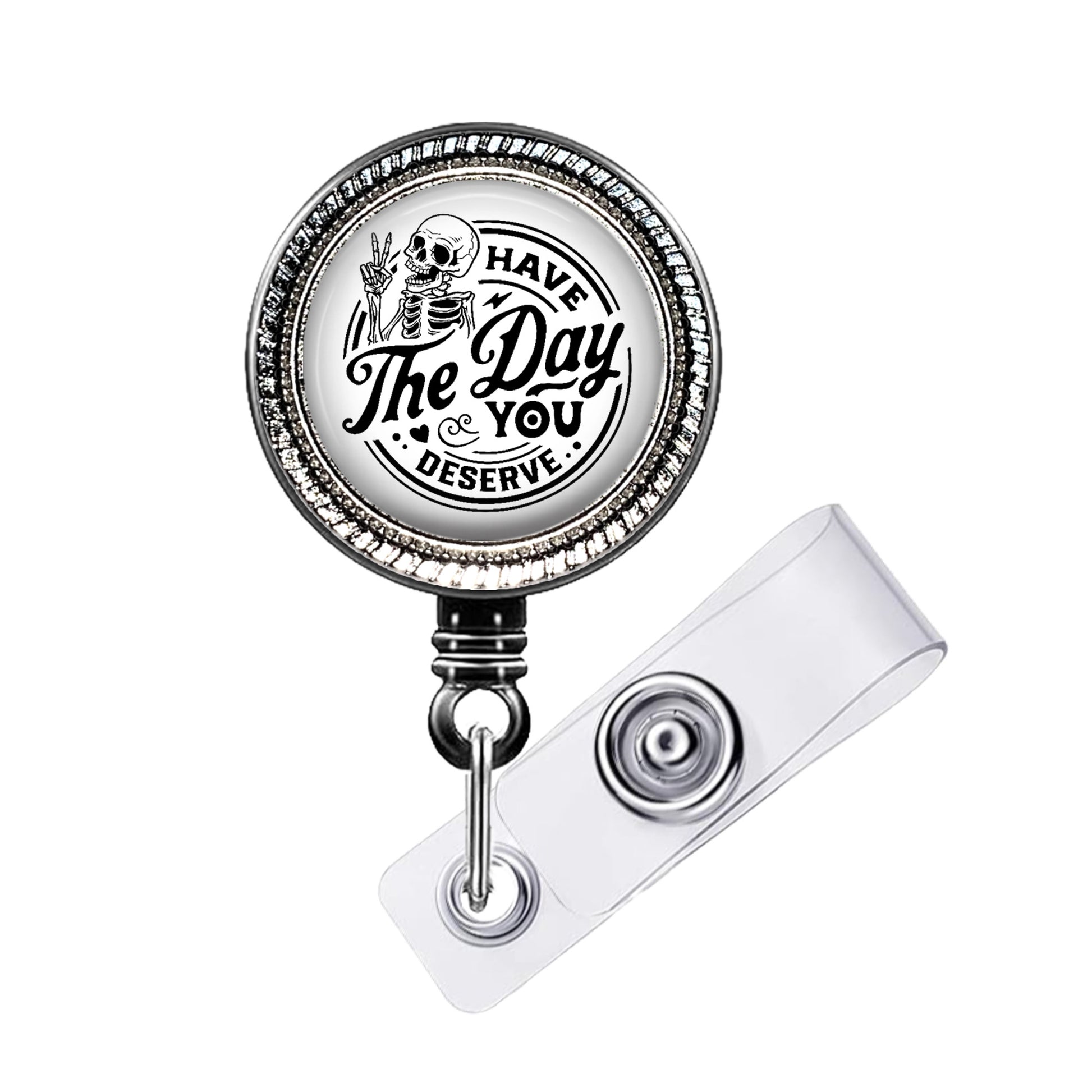 A metal badge holder with a circular design featuring a skeleton and the text "The Day & You Deserve".