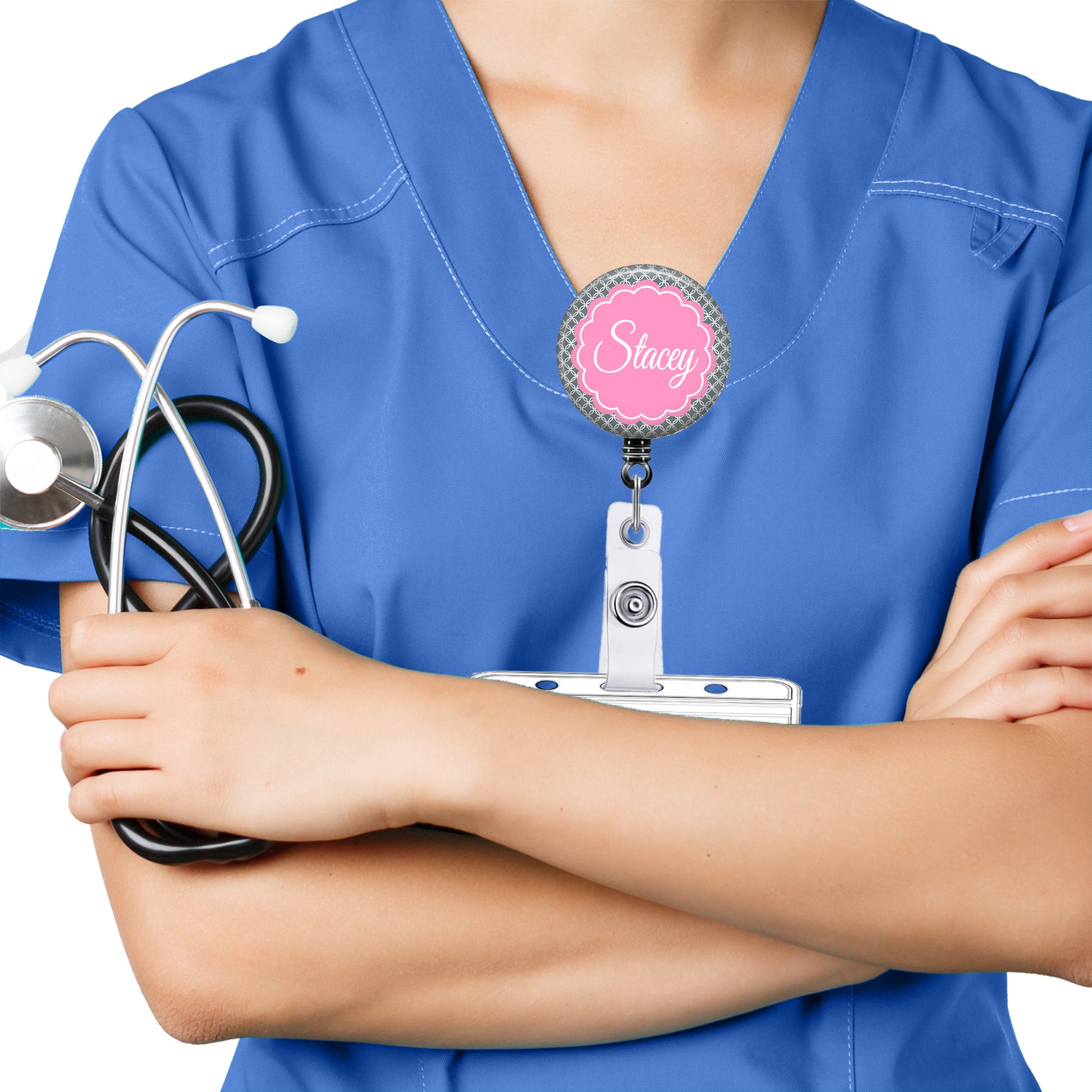A person wearing a blue medical uniform with a stethoscope around their neck and a personalized name badge.