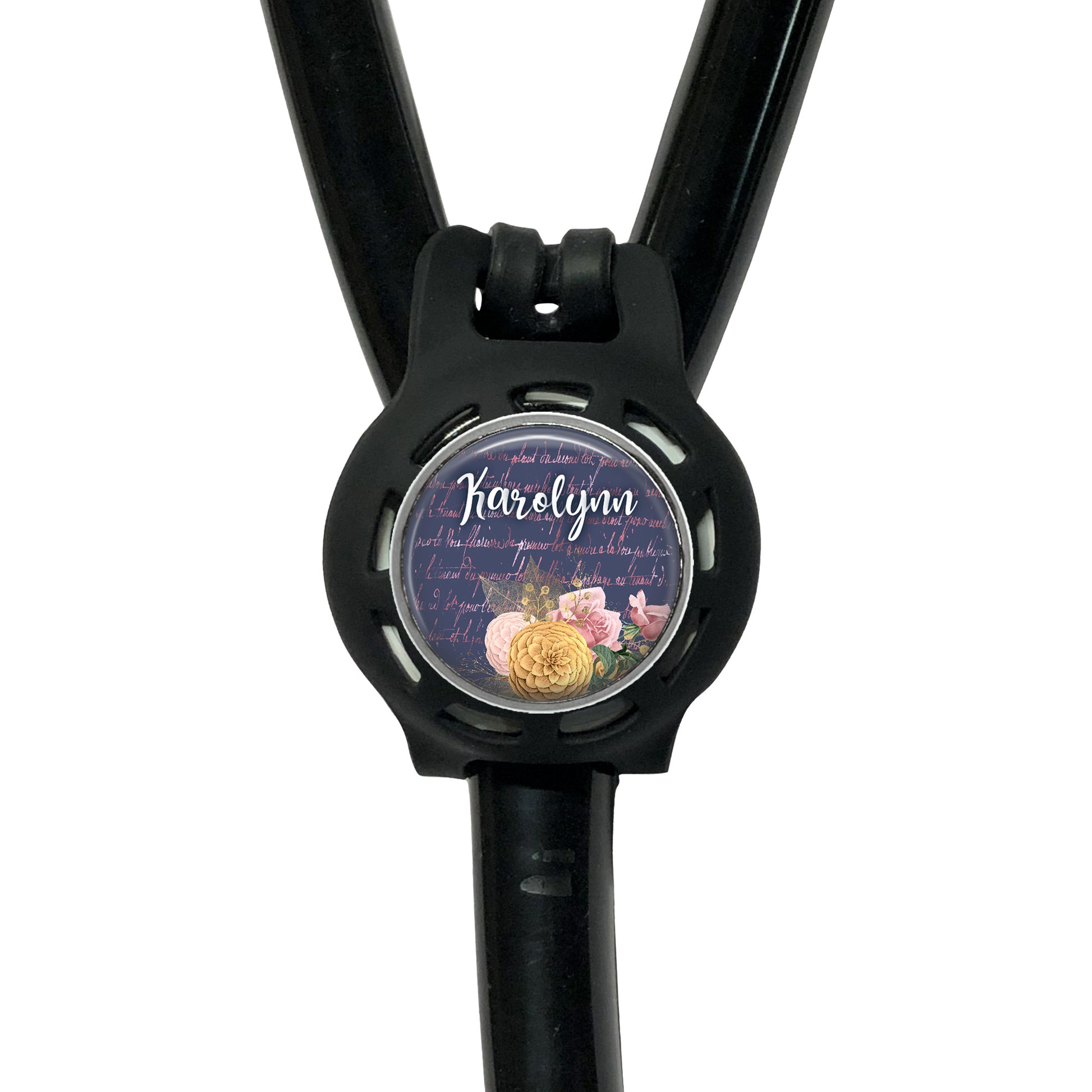 A black stethoscope with a round, personalized name tag attached to it.