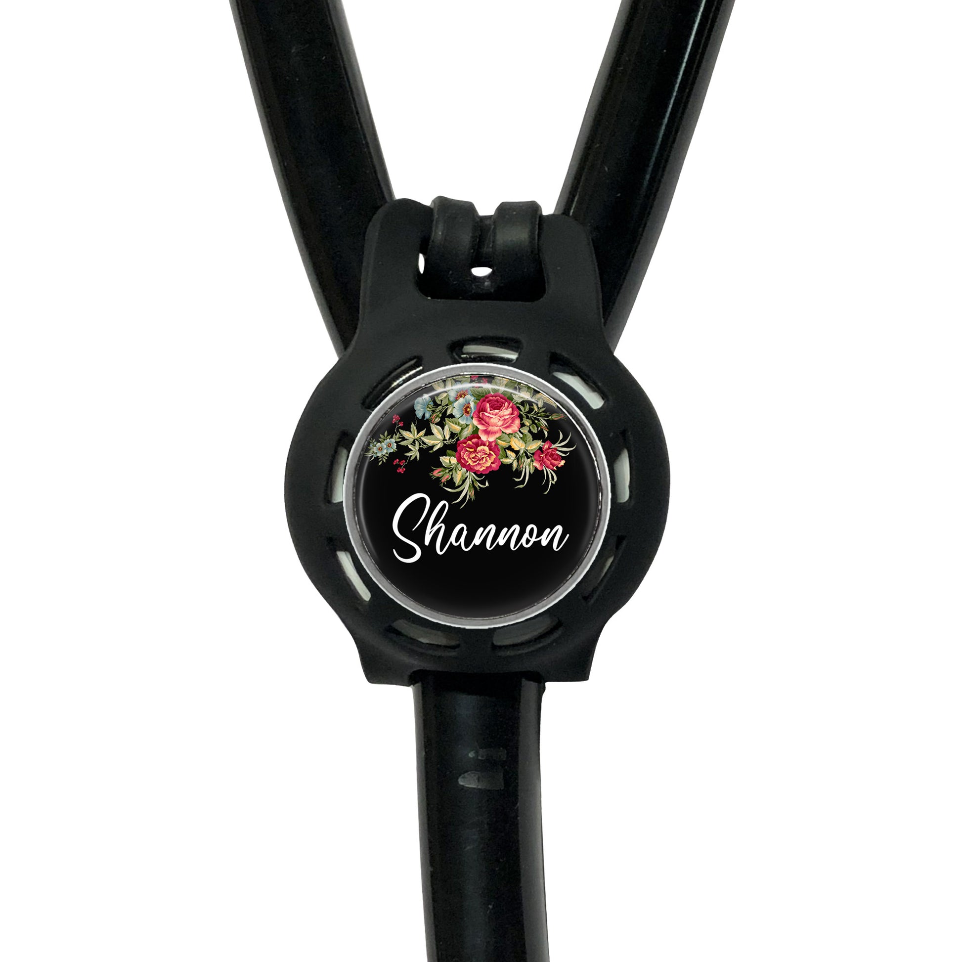 A black stethoscope with a floral design on the circular part of the tubing.
