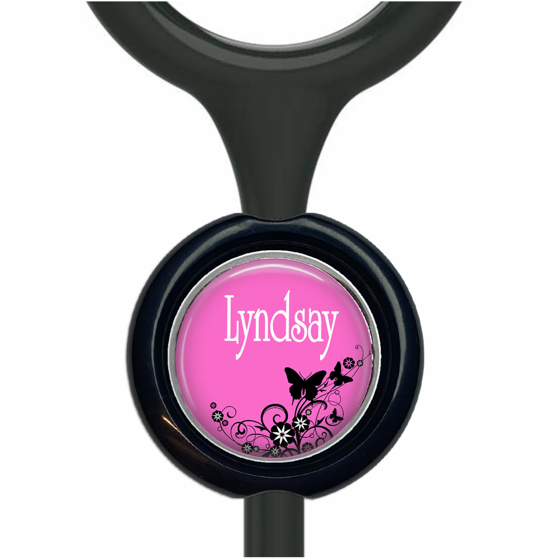 A pink circular button with the name "Lyndsay" written on it, surrounded by black floral designs.