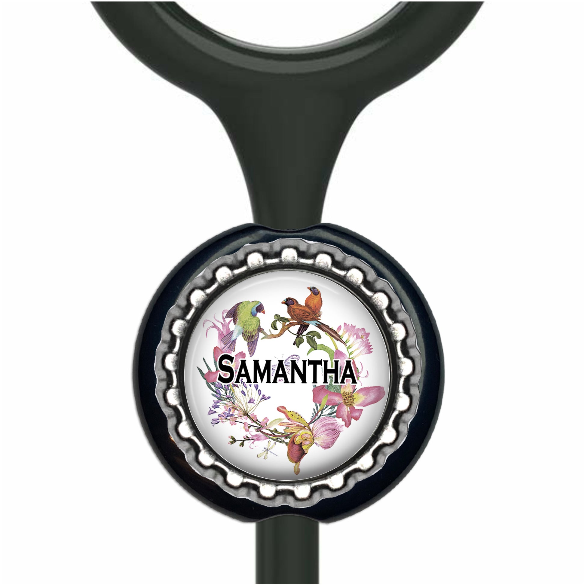 A personalized nameplate with a black handle and a round metal cap featuring a floral design and a bird illustration.